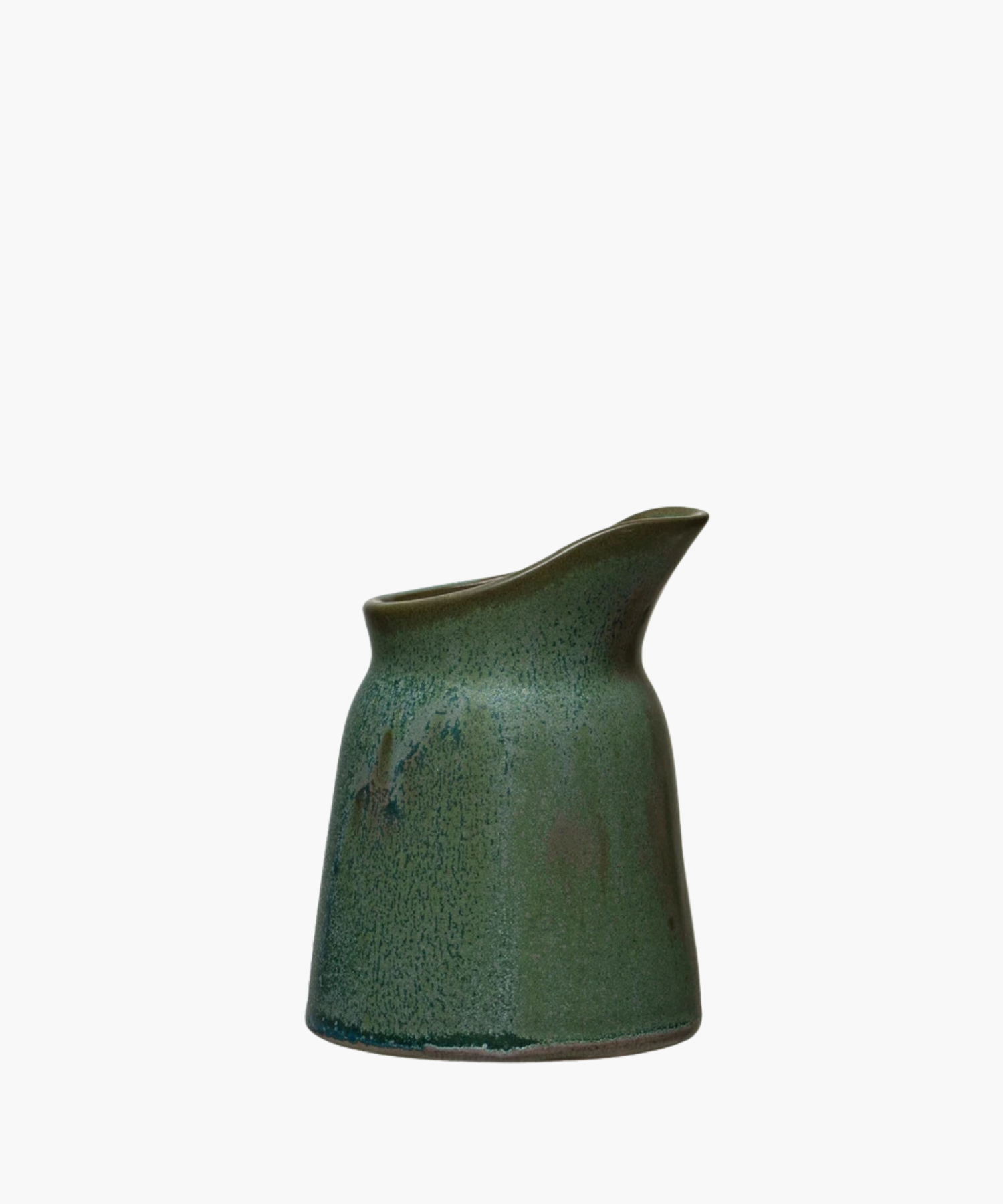 Green glazed ceramic creamer with a smooth, speckled texture and a curved spout. The design is modern and minimalist, evoking calm and simplicity. | S.W. Home