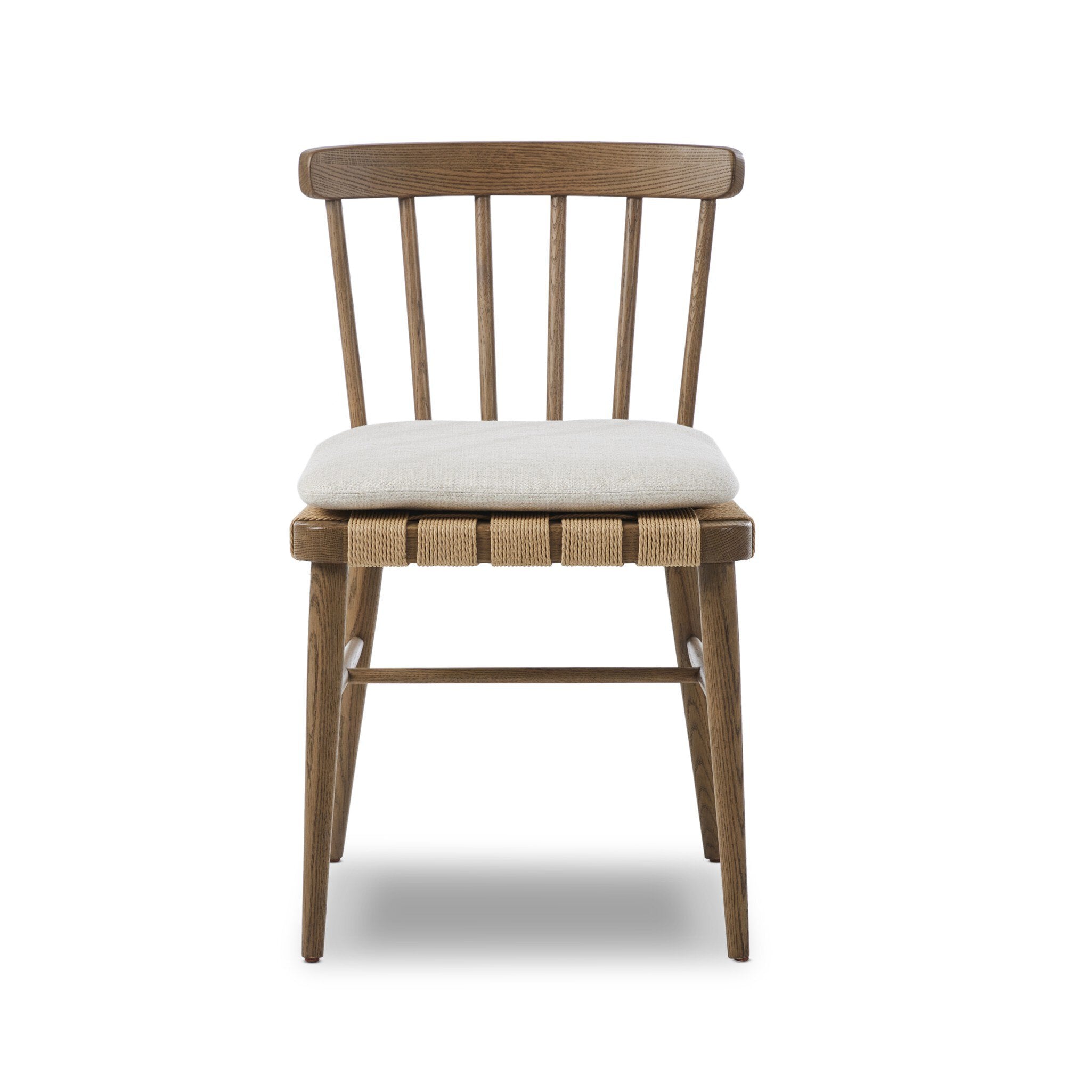 Wooden chair a spindle back, grid-woven seat, and a white cushion on a white background. | S.W. Home