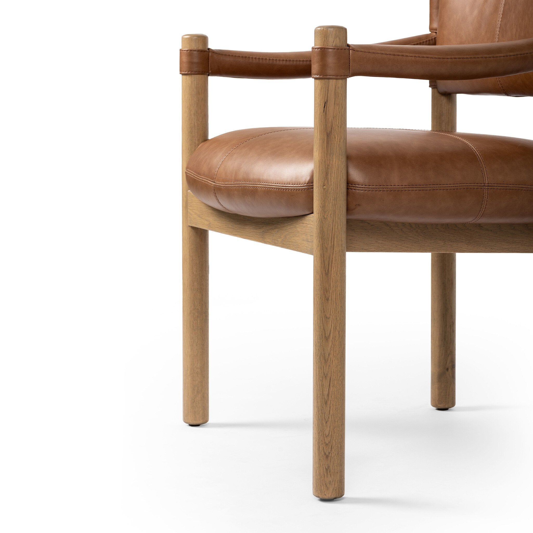 Brown leather dining armchair with wooden frame on a white background.