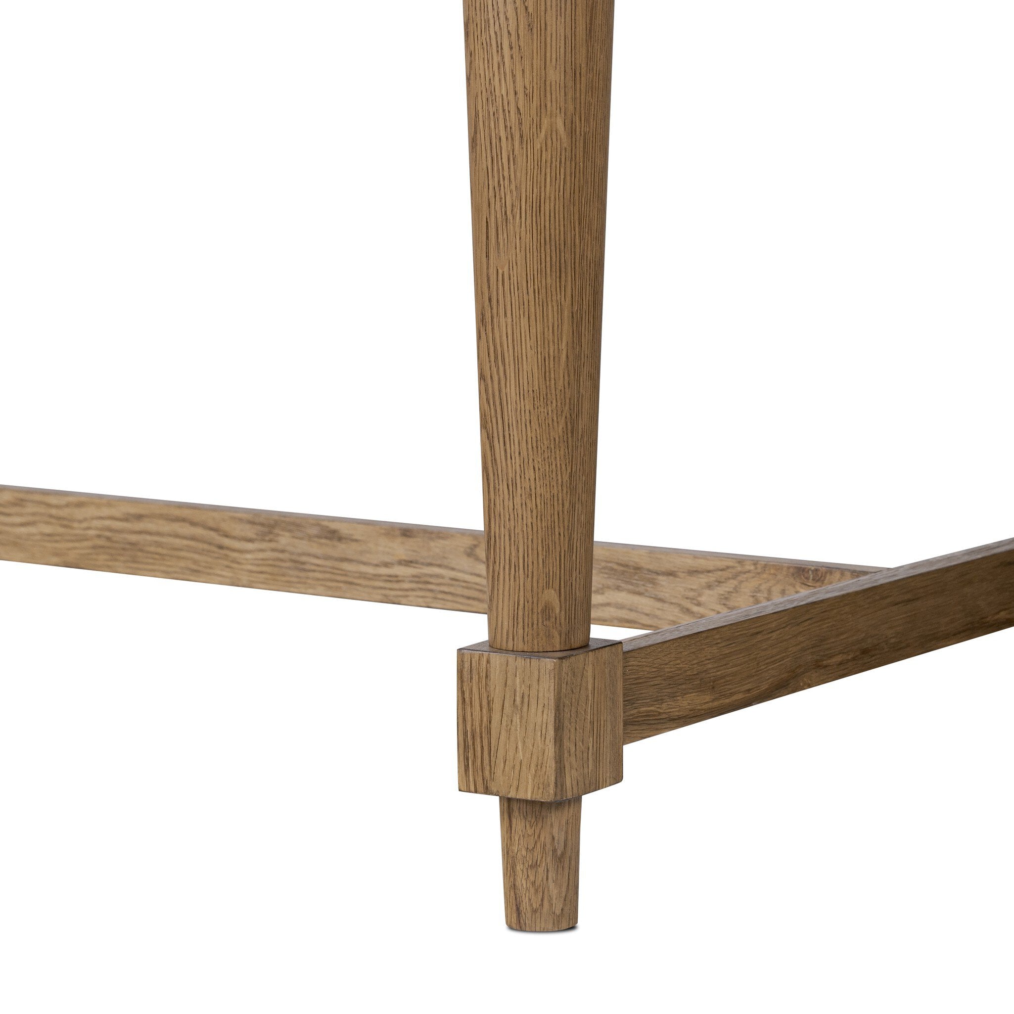 Close up of a rectangular wood dining table on a white background.