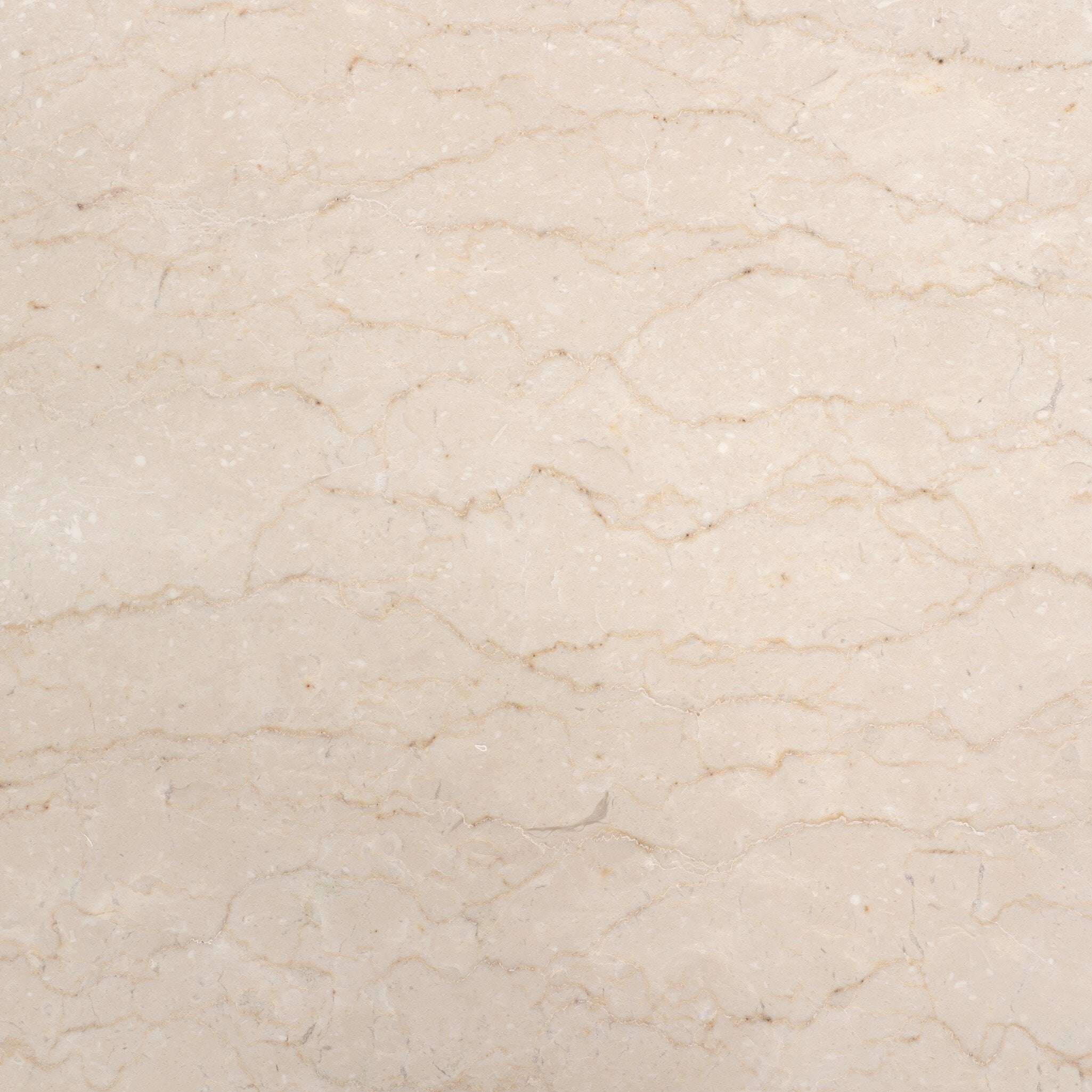 Close up of the cream-white marble top showing the color and veining.