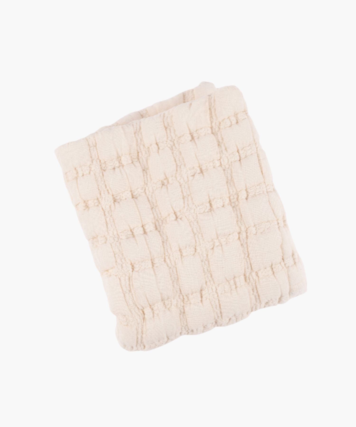 Folded view of a cream quilt with a soft, puffed grid texture and subtle stitched detailing. | S.W. Home