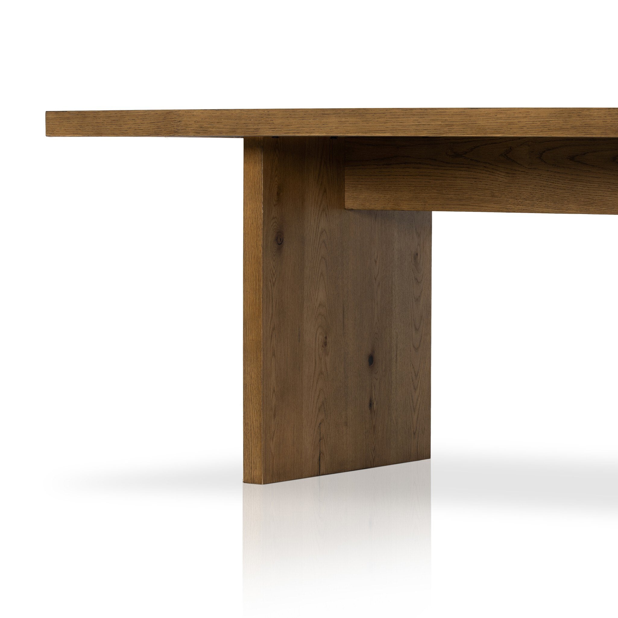 Close up of a wood dining table on a white background.