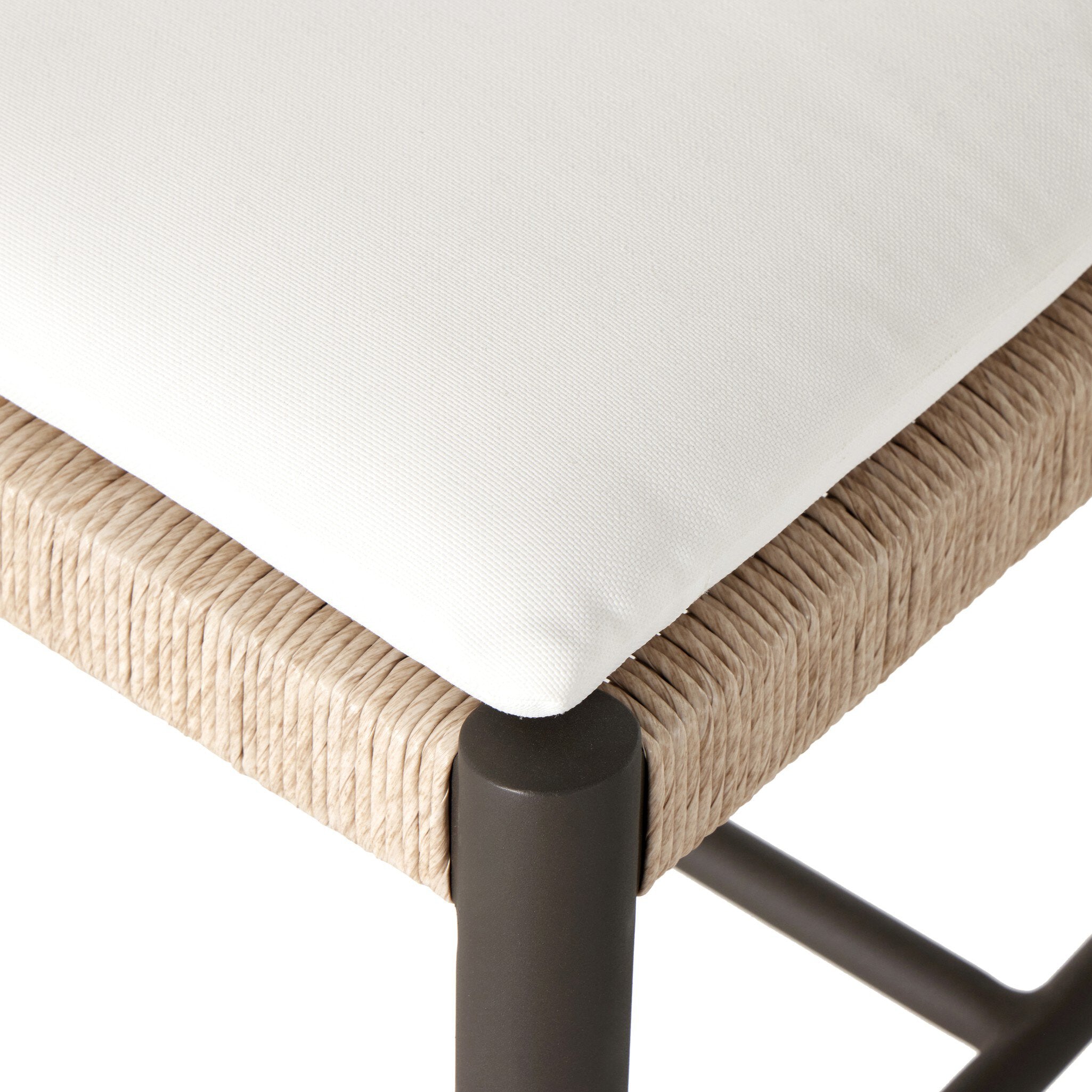 Close up of a classic ladderback outdoor dining chair with a woven seat and removable cushion.