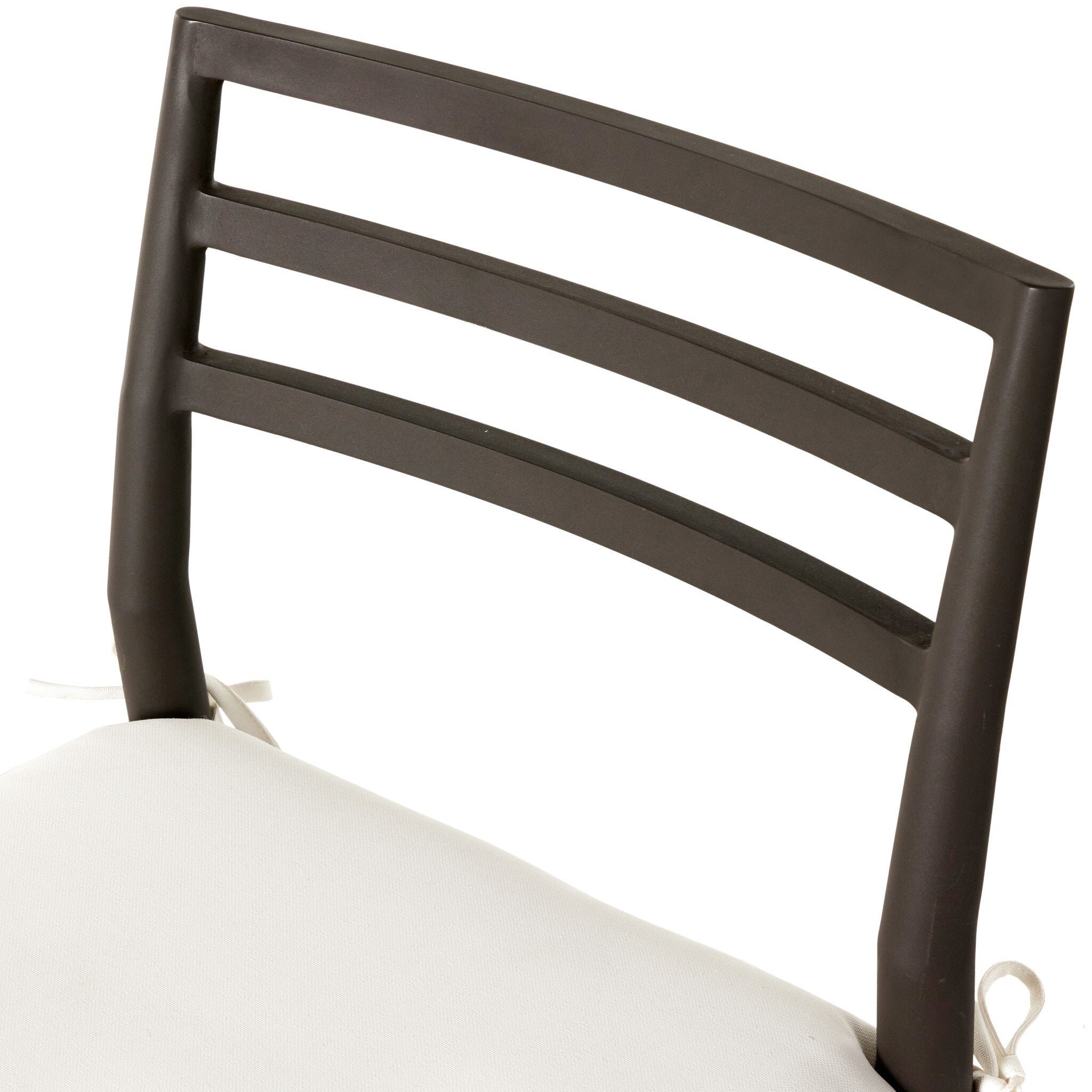 Close up of a classic ladderback outdoor dining chair with a woven seat and removable cushion.