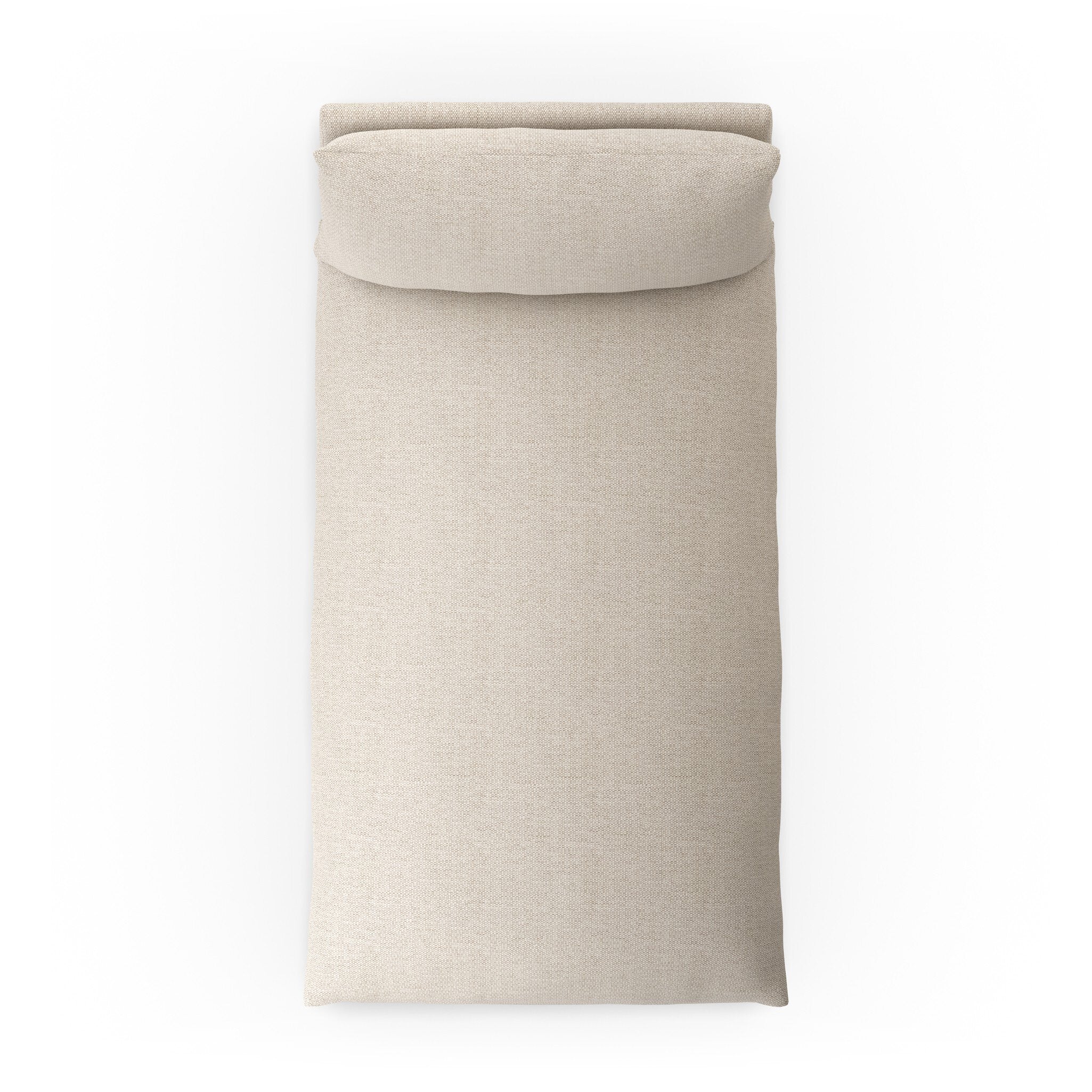 Overhead view of a chaise section of a beige slipcover outdoor sofa on a white background.