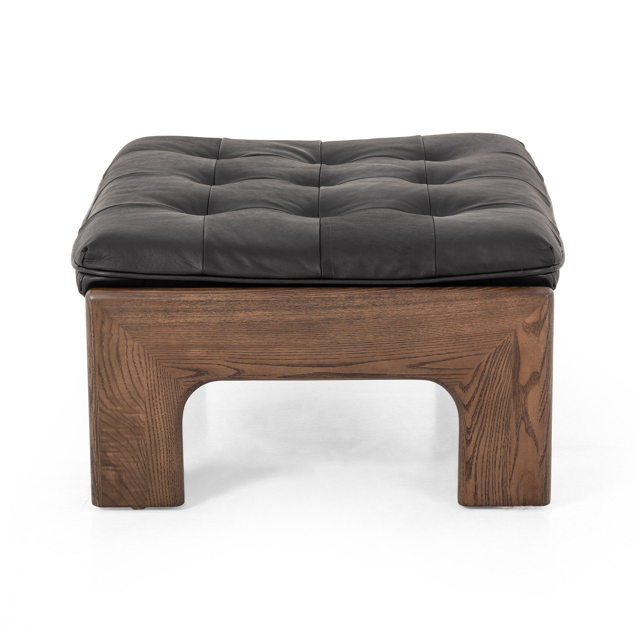 Side profile of a black leather cushioned ottoman with wooden frame on a white background.