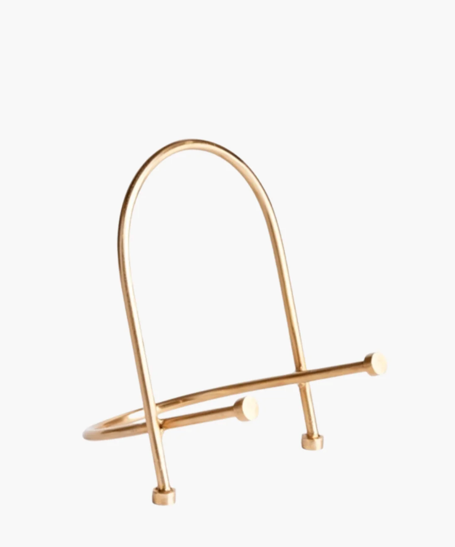 A modern, gold finished metal easel stand with a minimalist design. It features a sleek, arched shape with two crossbars at the base. | SW Home