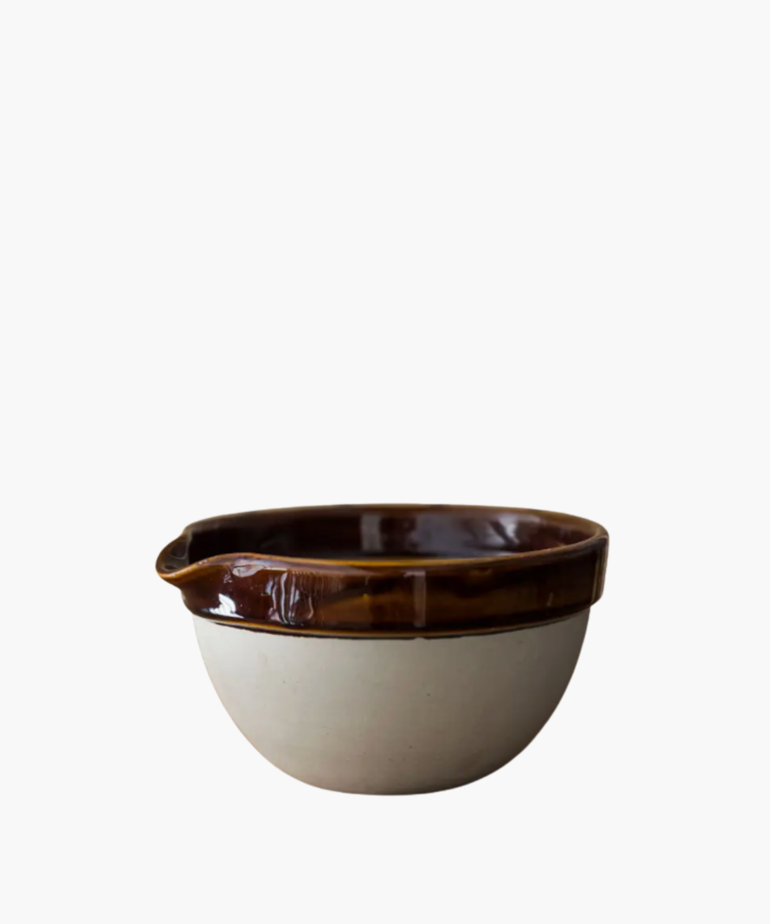 A ceramic bowl with a glossy brown rim and matte beige exterior. The design is rustic and visually pleasing. | S.W. Home