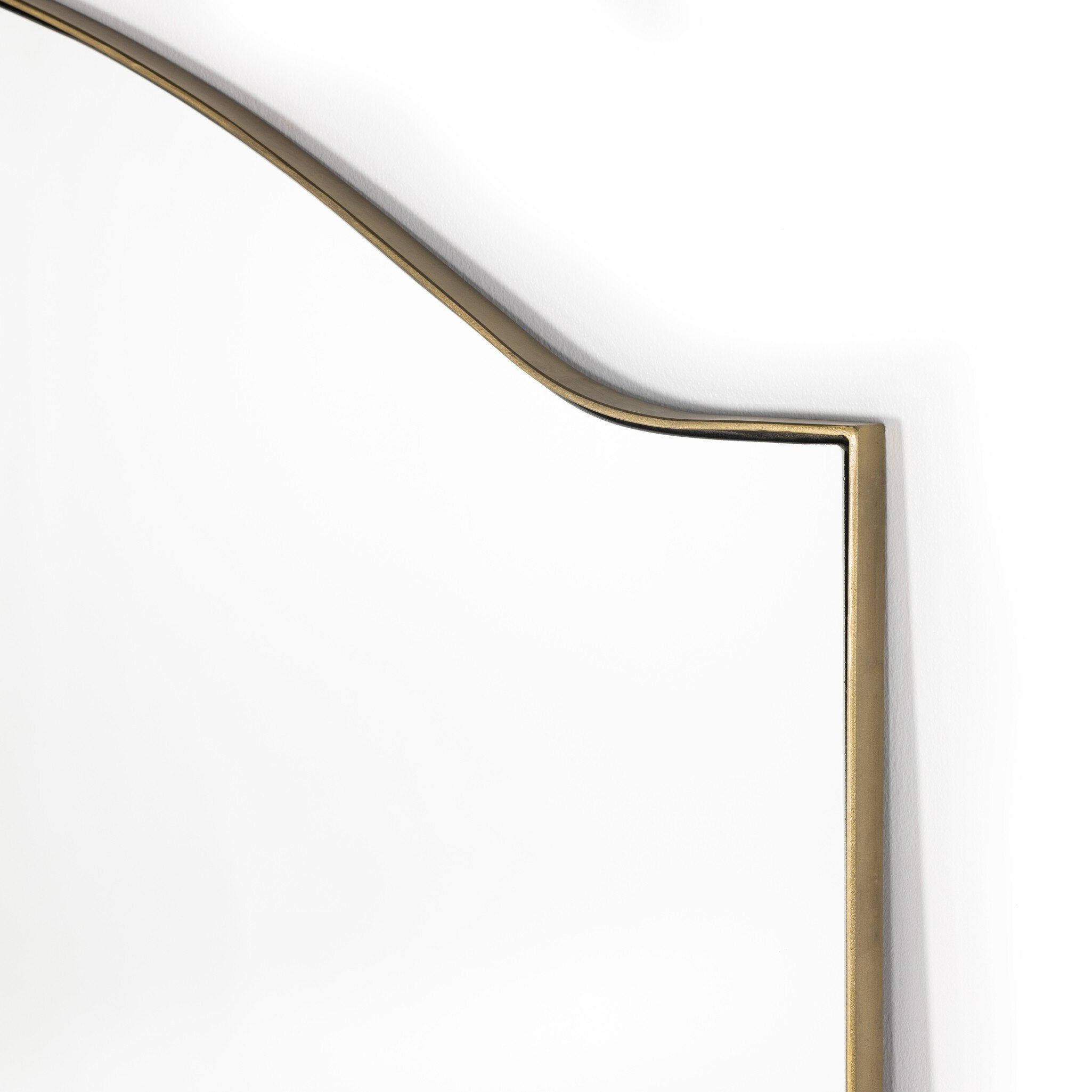 Rectangular floor length mirror with curved detail and a gold frame on a white background.