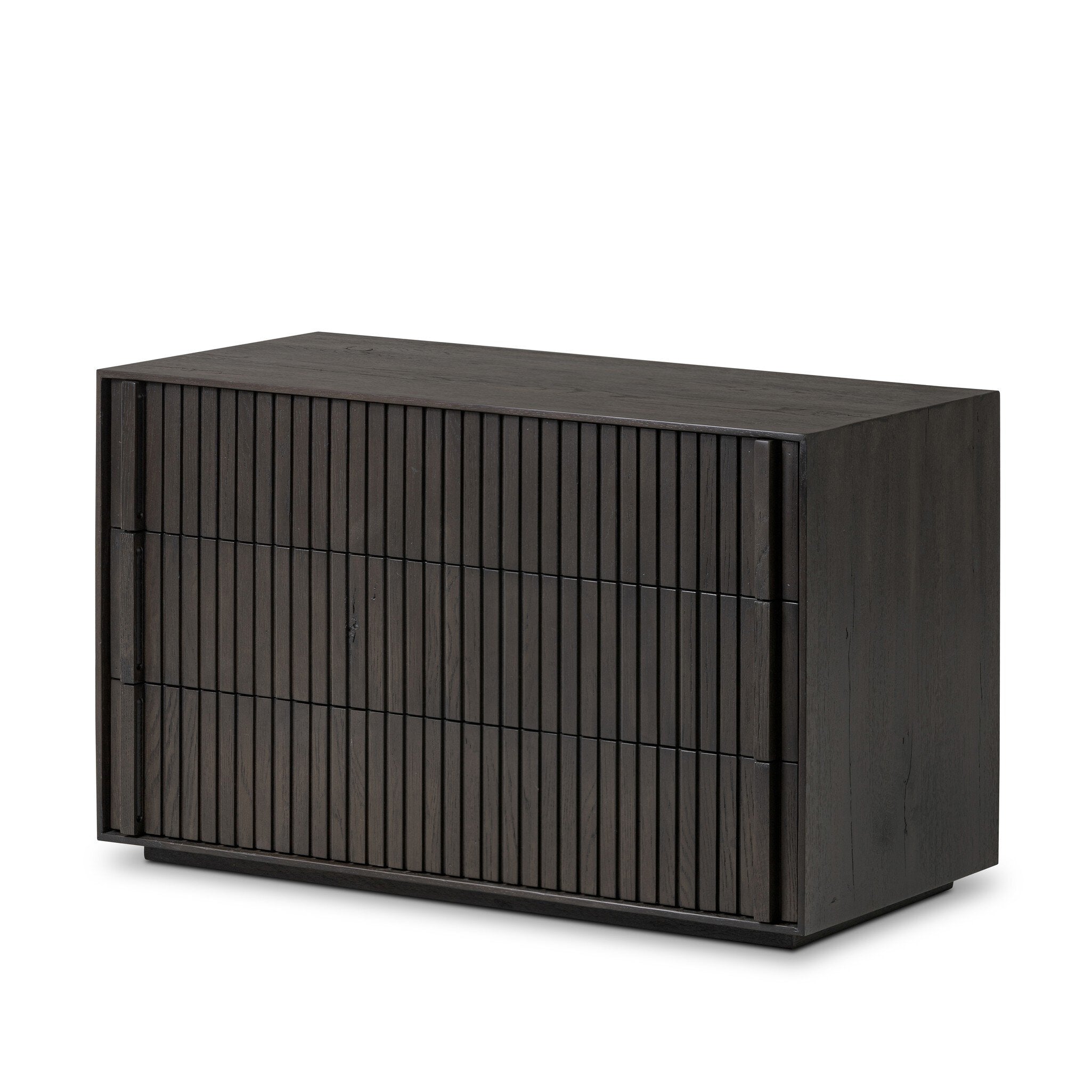 Dark wooden dresser with vertical reed detailing and three drawers on a white background.