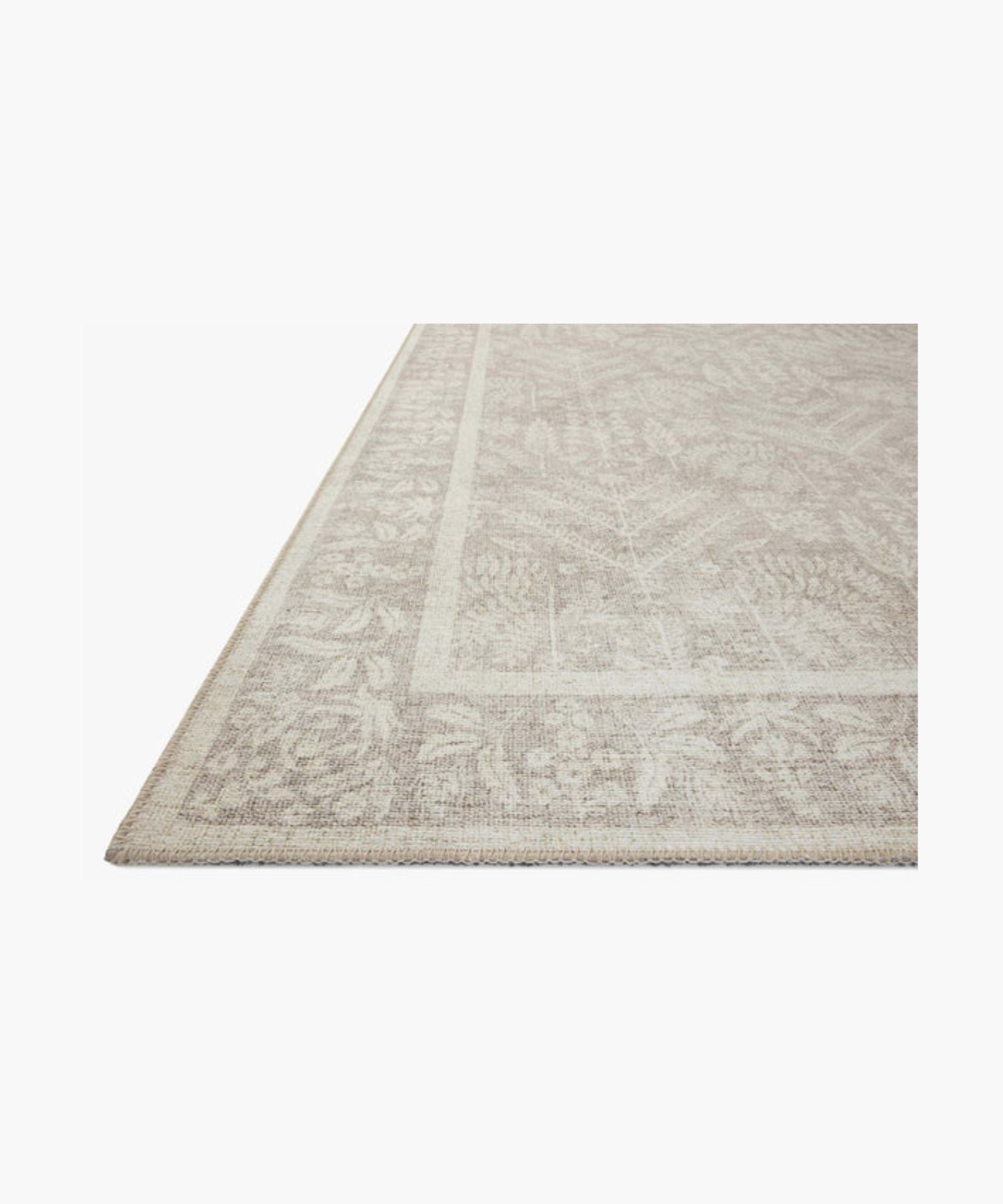 A beige area rug with an intricate floral and leaf pattern bordered by a thicker floral edge. The design is symmetrical and elegant, adding a soft, classic touch. | SW Home
