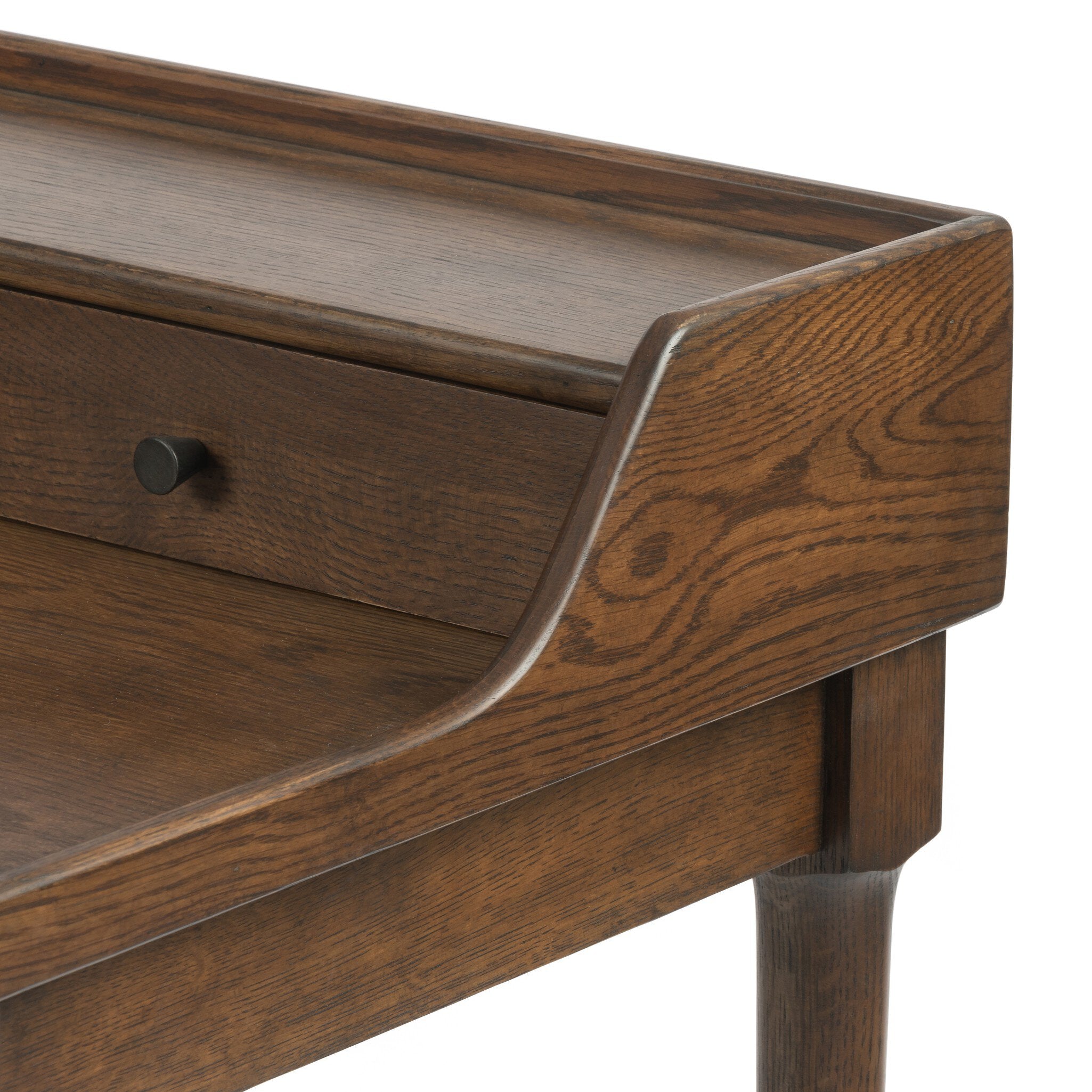 Close up of a wooden desk with drawers on a white background.