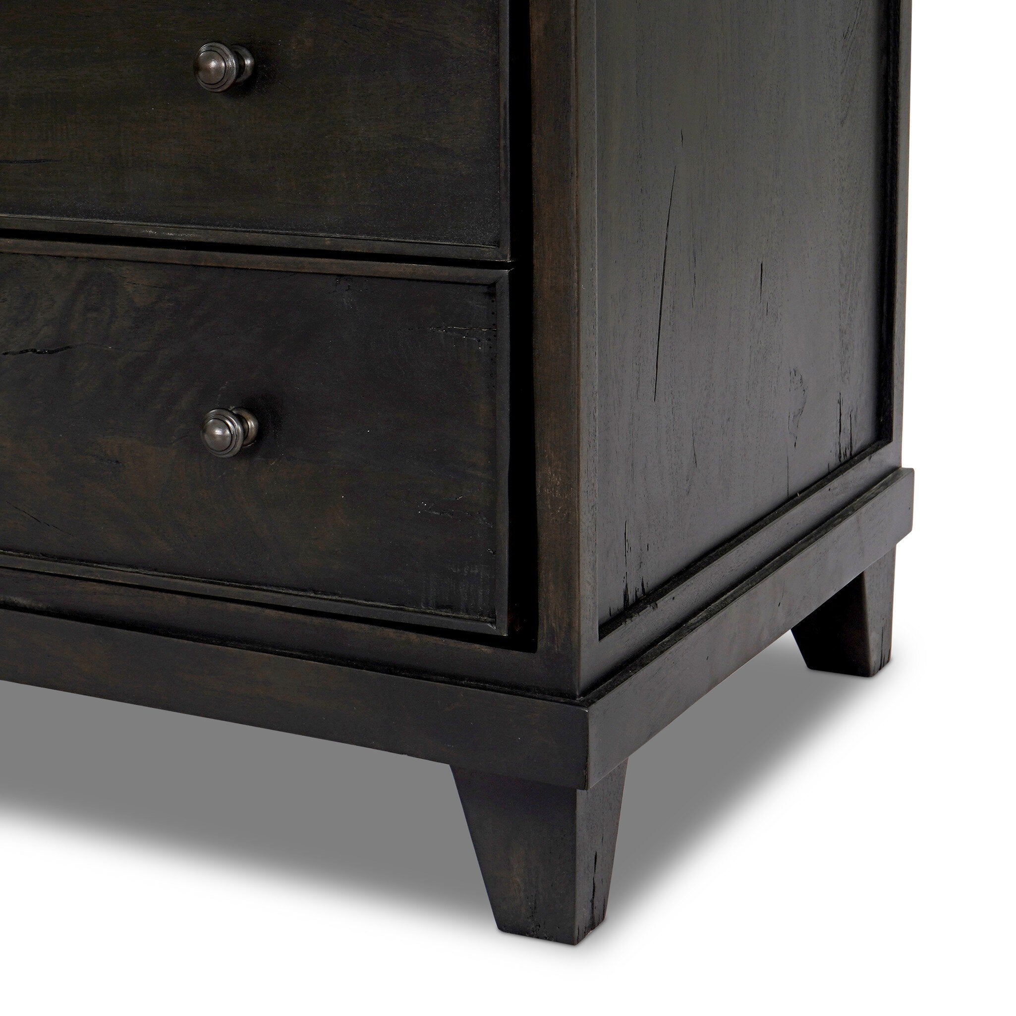 Close up of a dark wood stained nightstand with three drawers and a marble top.