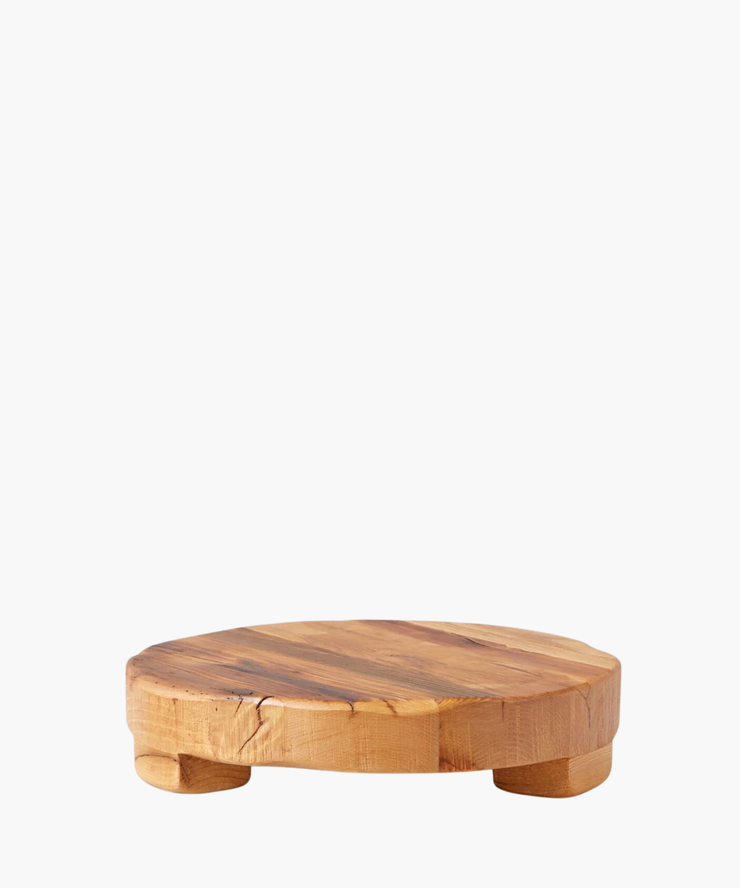 Round wooden pedestal or trivet made of smooth, natural wood with subtle grain patterns, supported by small rounded legs. Conveys rustic and minimalist elegance. | S.W. Home