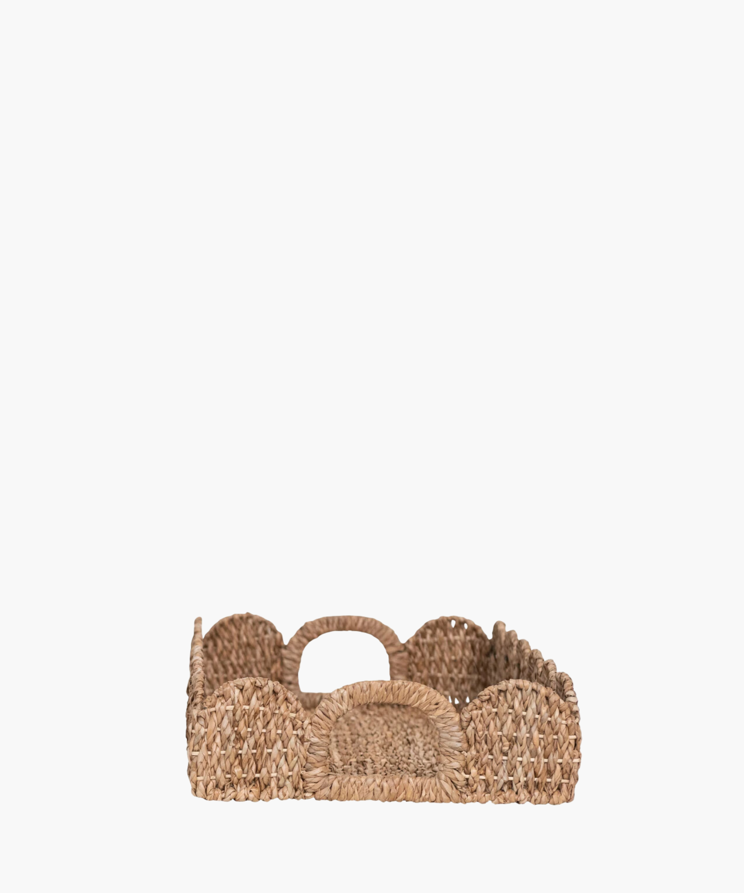 A side profile picture of rectangular woven tray with scalloped edges highlighting the curved handle. The natural brown hue adds a rustic, earthy charm. | SW Home