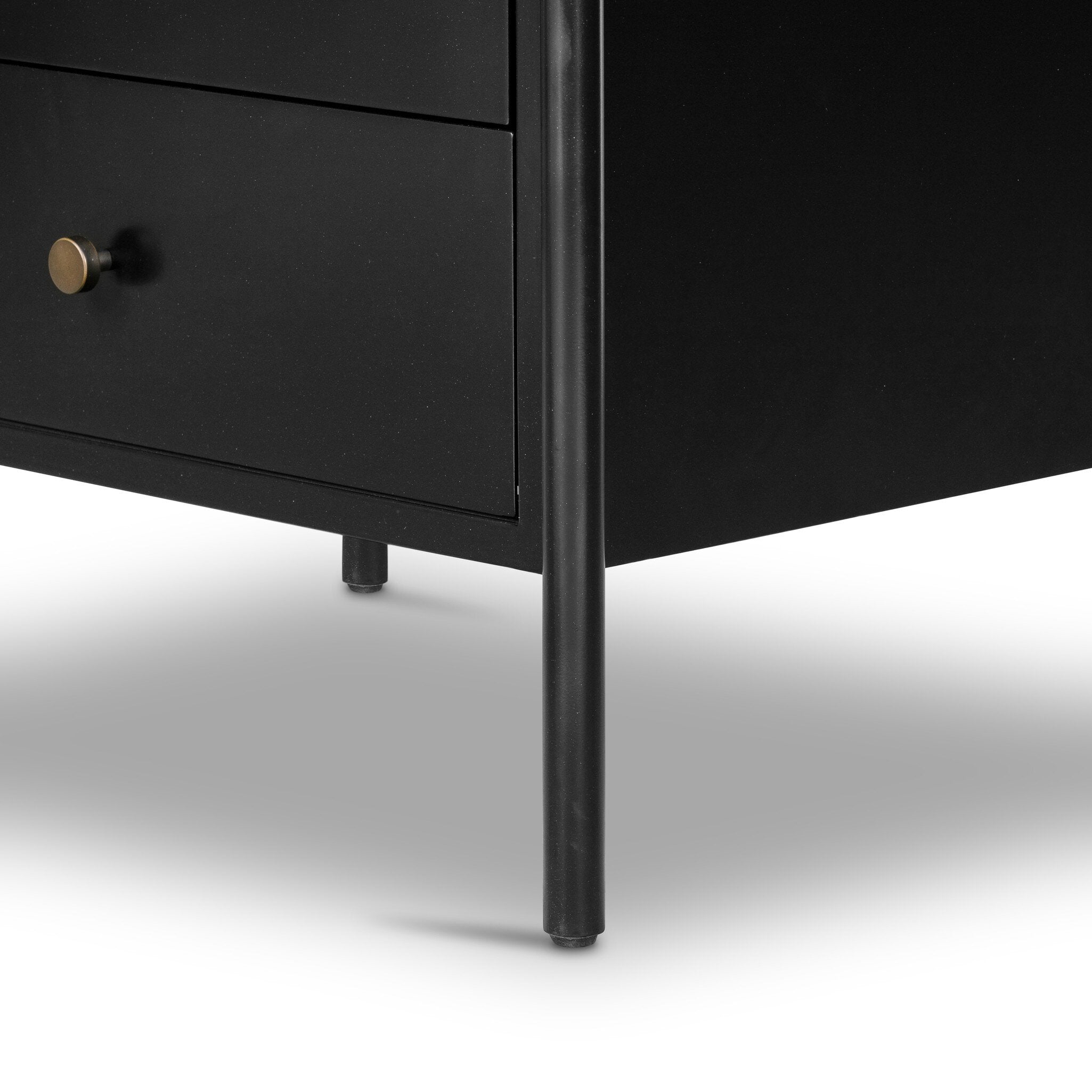 The back of a black dresser with three drawers on a white background.