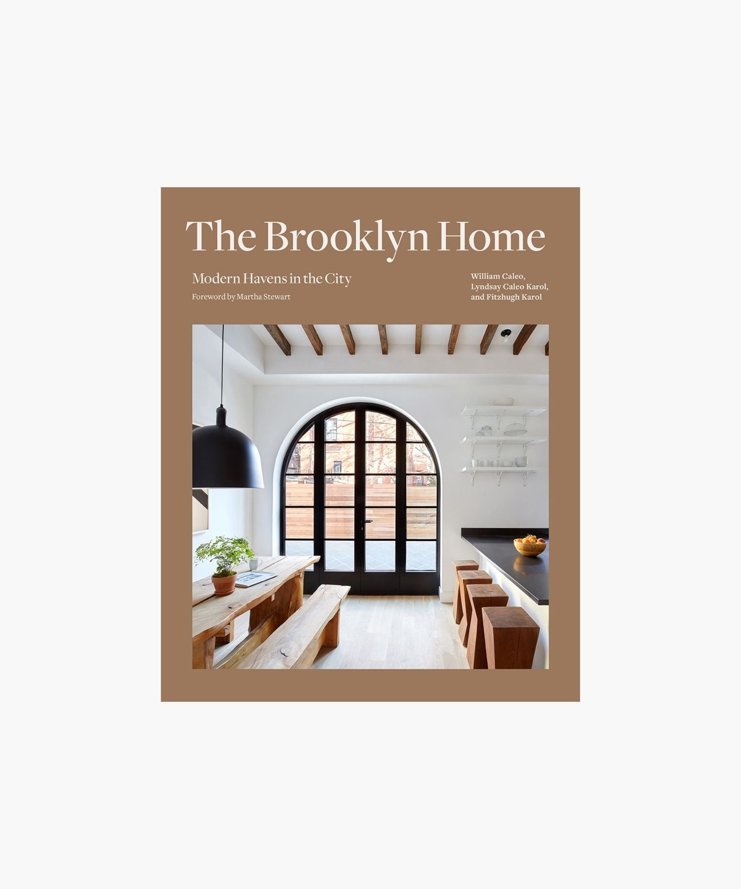 The cover of the book "The Brooklyn Home" shows a modern dining room with exposed beams, a large arched window, wooden furniture, and a plant. Minimalist and inviting. | S.W. Home