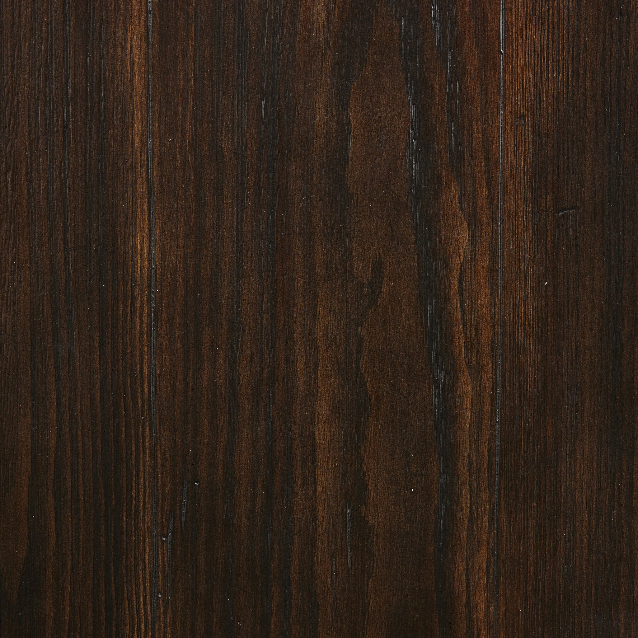 Close up of the brown-finished pine showing its rich color and graining.