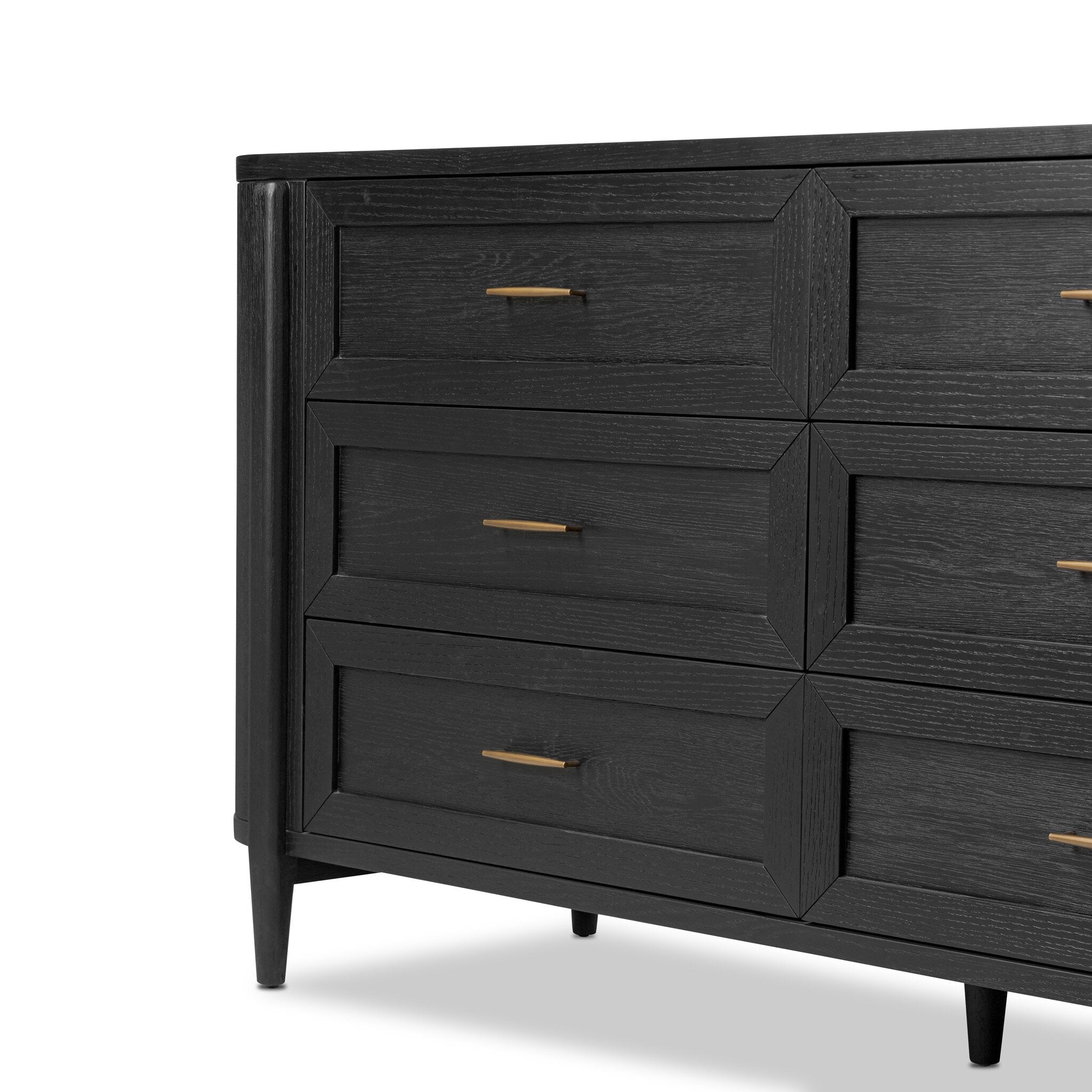 Close up of a curved black dresser with brass handles on a white background.