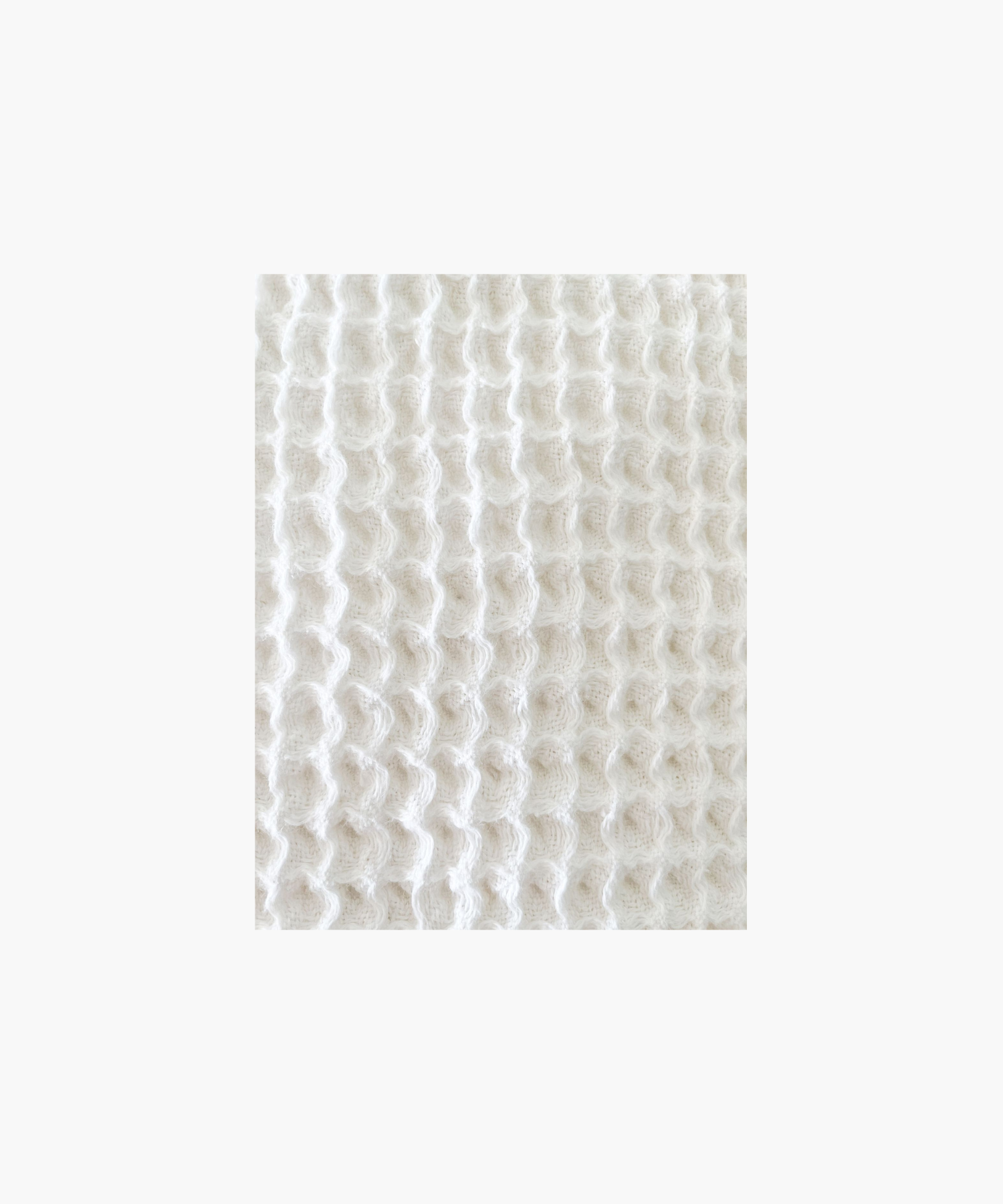 A gray Turkish cotton waffle bath towel with a fringe border.
