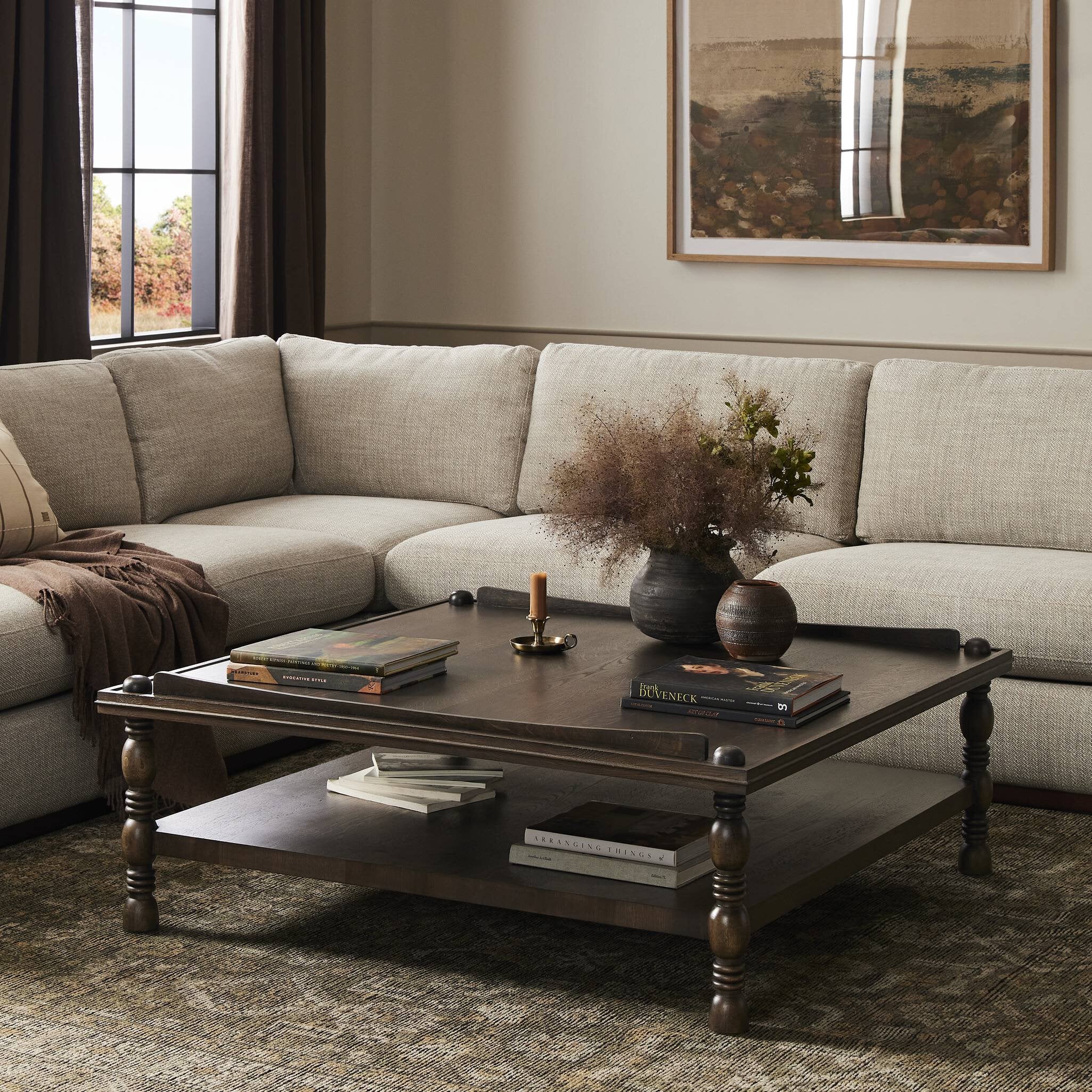 Living room with a sectional sofa and wooden coffee table.