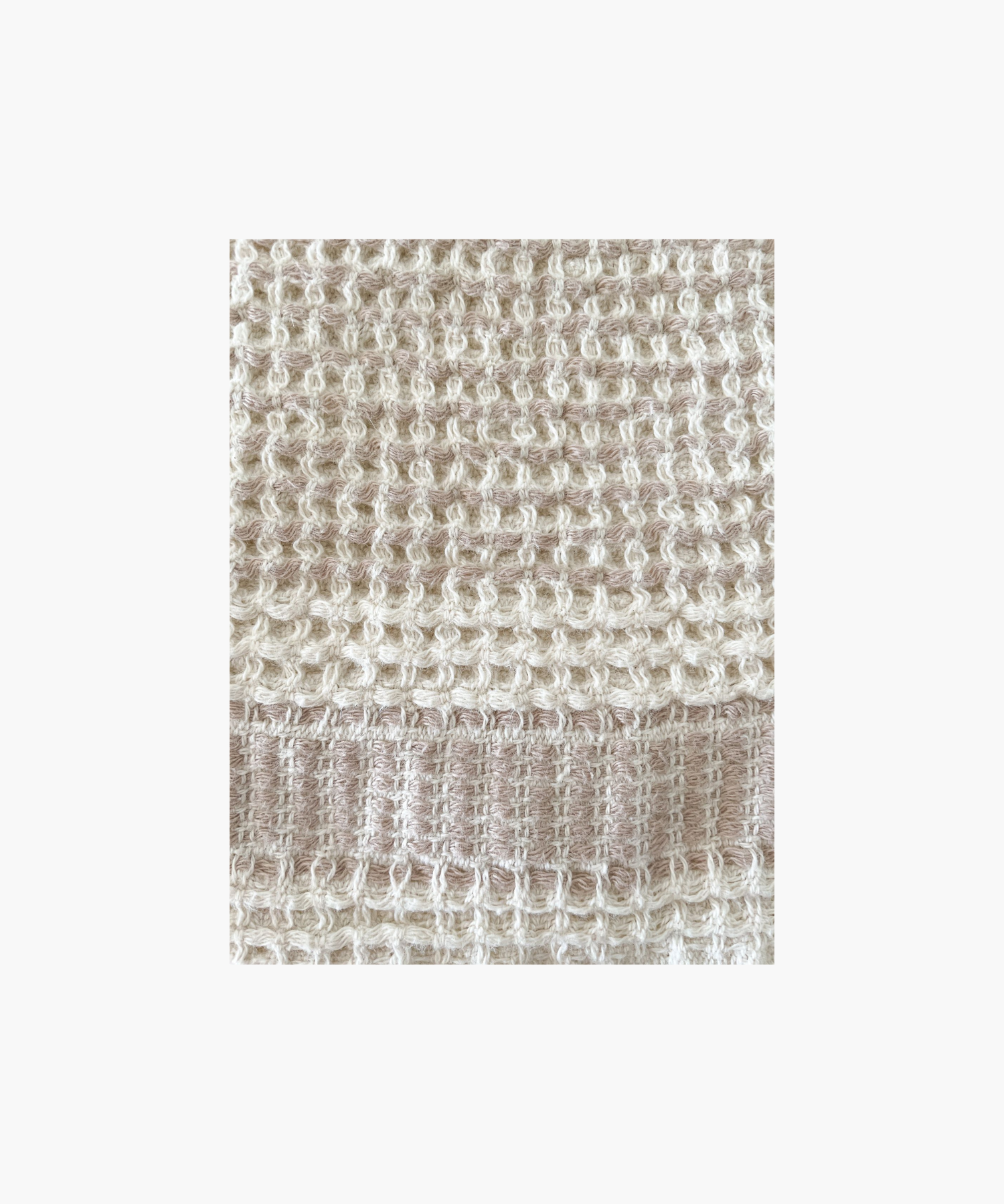A Waffle Striped Turkish Cotton Bath Towel in a beige color with a bold stripe and self fringe.
