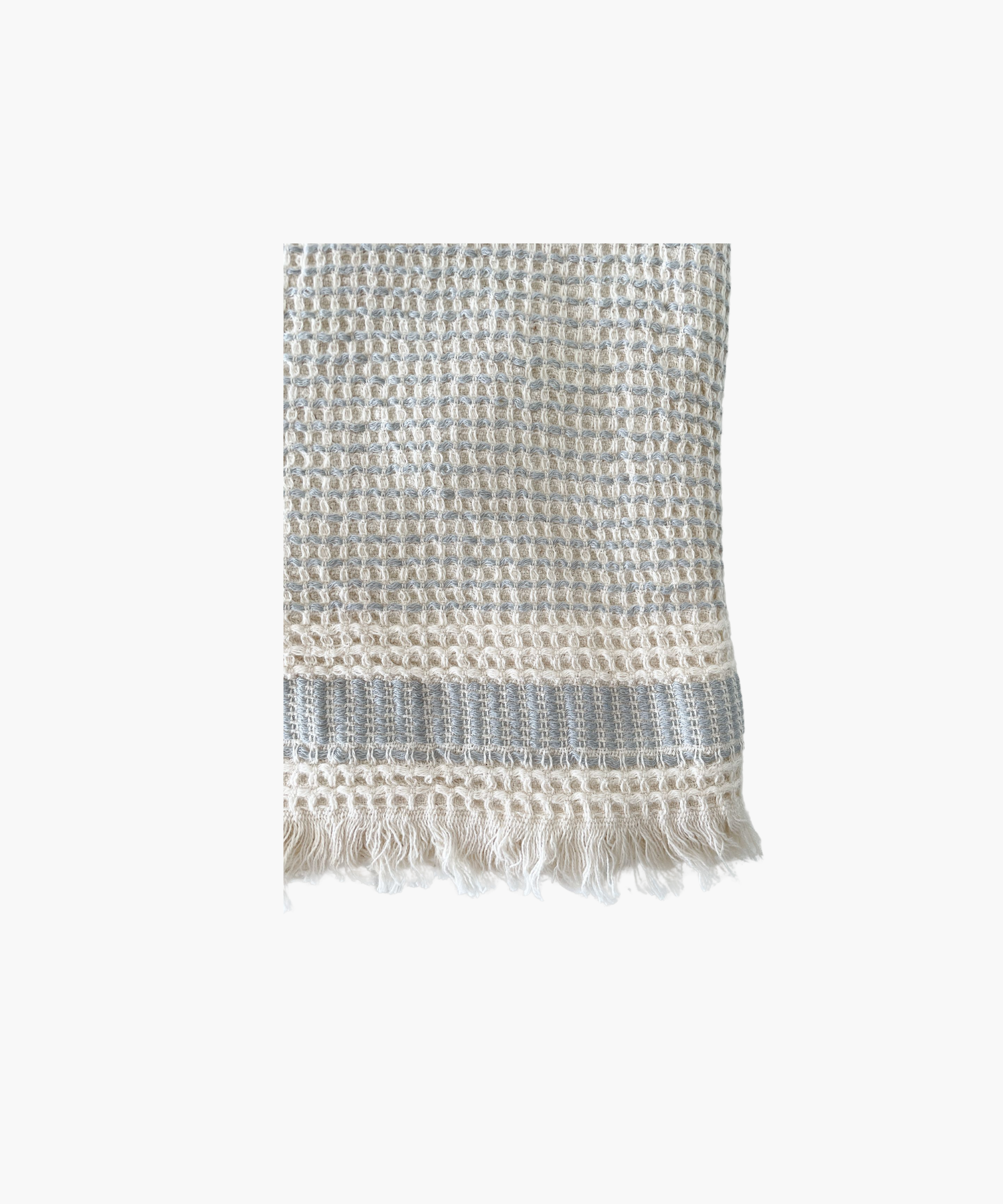 A Waffle Striped Turkish Cotton Bath Towel in a beige color with a bold stripe and self fringe.
