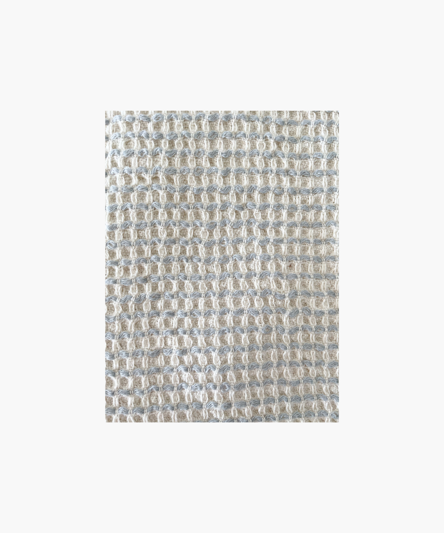 A Waffle Striped Turkish Cotton Bath Towel in a beige color with a bold stripe and self fringe.