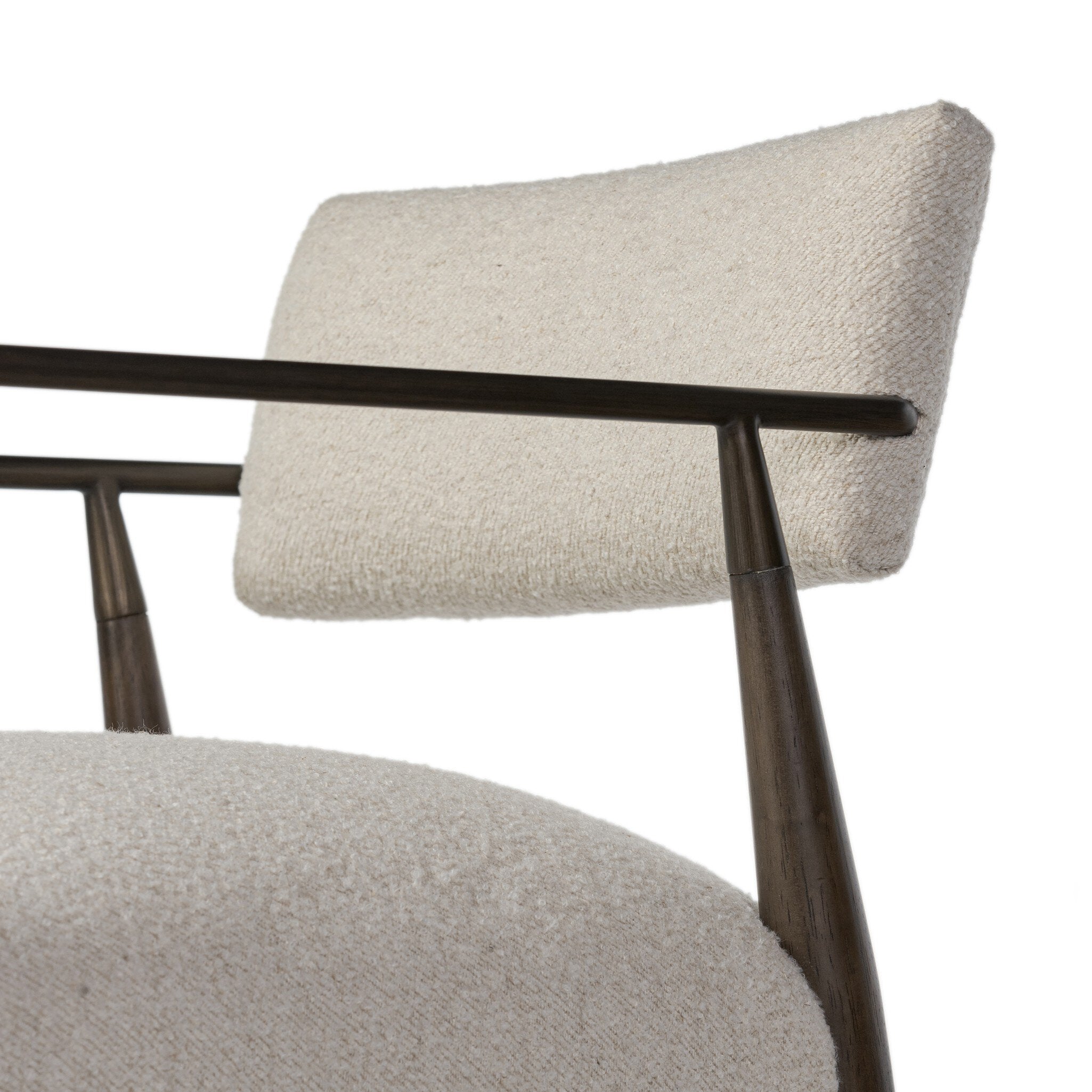 Close up of a beige counter stool with wooden frame on a white background.