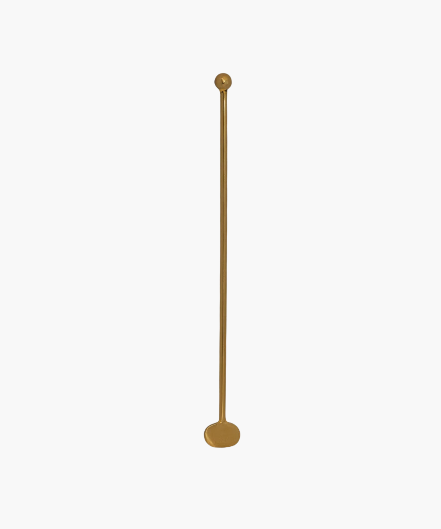 A long, slender brass cocktail stirrer with a rounded base and a small, spherical top placed against a plain white background. | S.W. Home