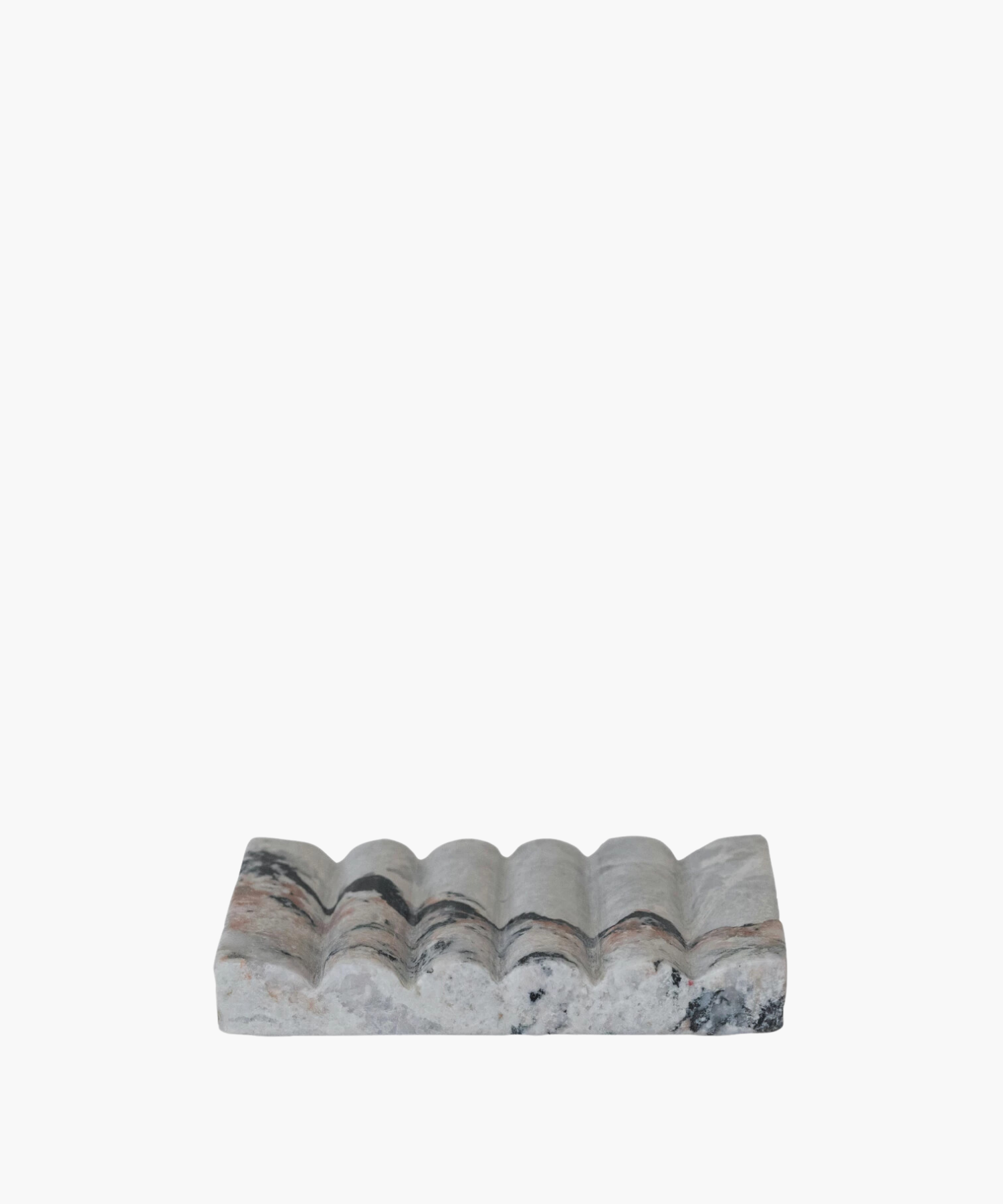 A rectangular marble soap dish with a wavy, textured surface. The stone features gray, black, and pink veins, conveying an elegant and natural aesthetic. | S.W. Home