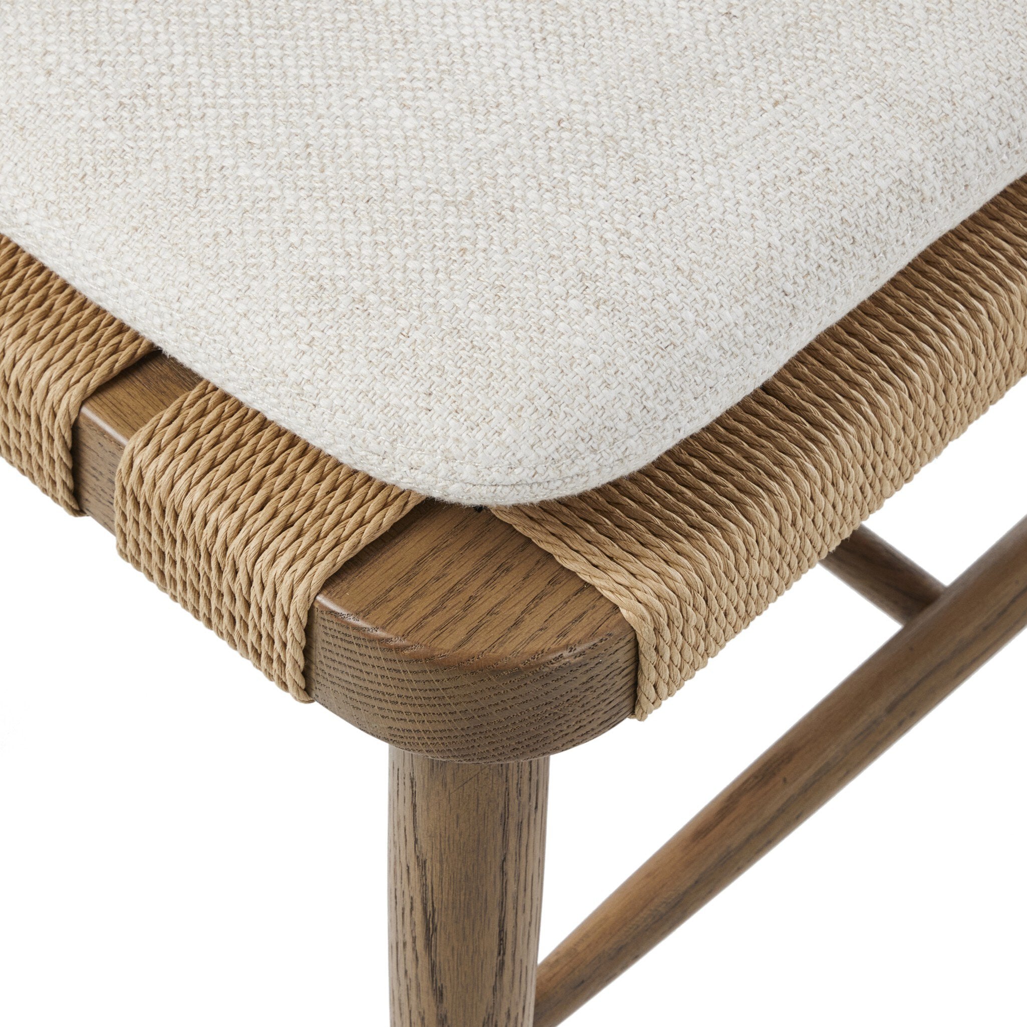 Close-up of a chair with woven seat and wooden frame on a white background