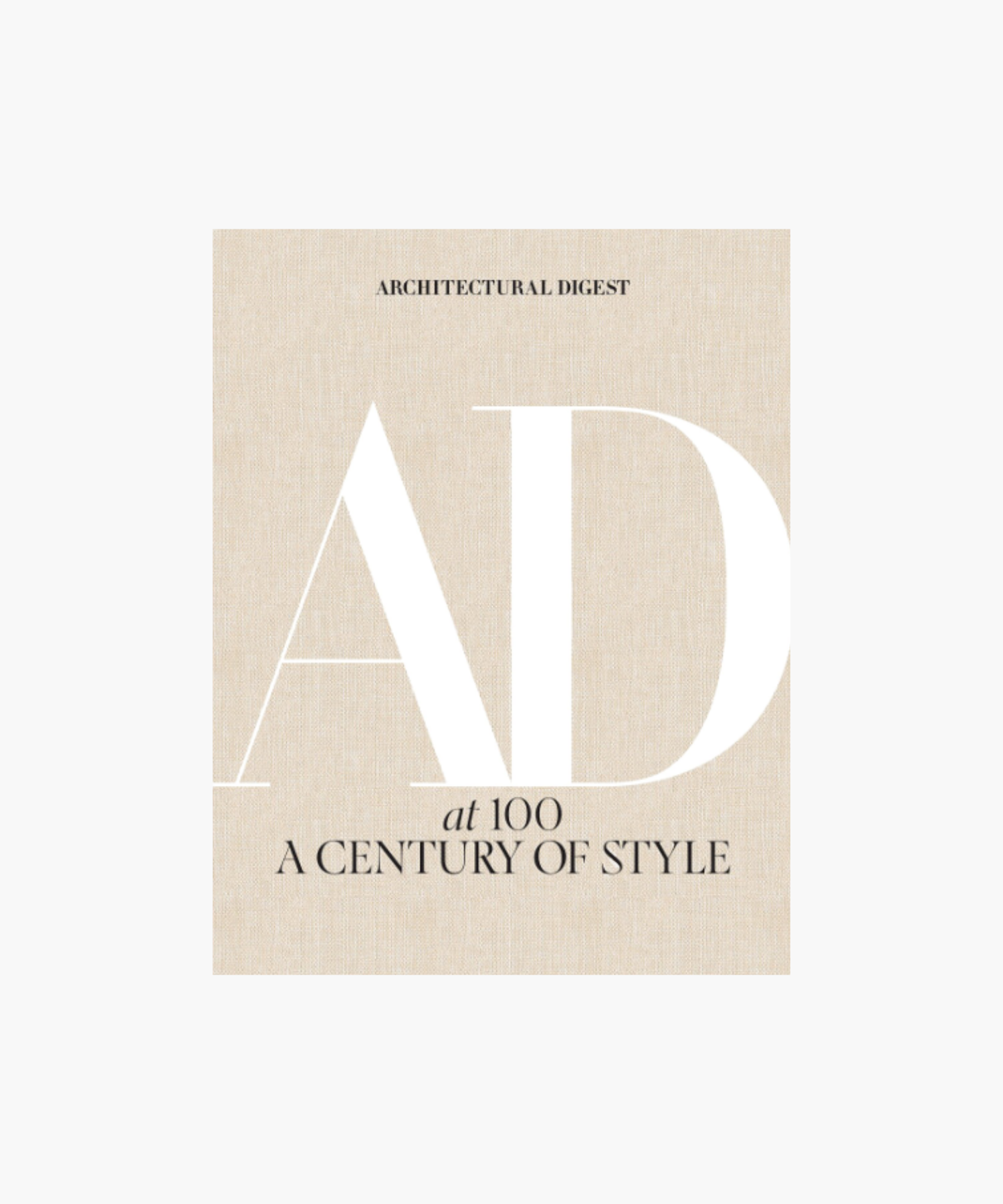 The cover of the book "Architectural Digest: AD at 100, A Century of Style" featuring large white "AD" letters on a textured beige background, conveying elegance. | S.W. Home