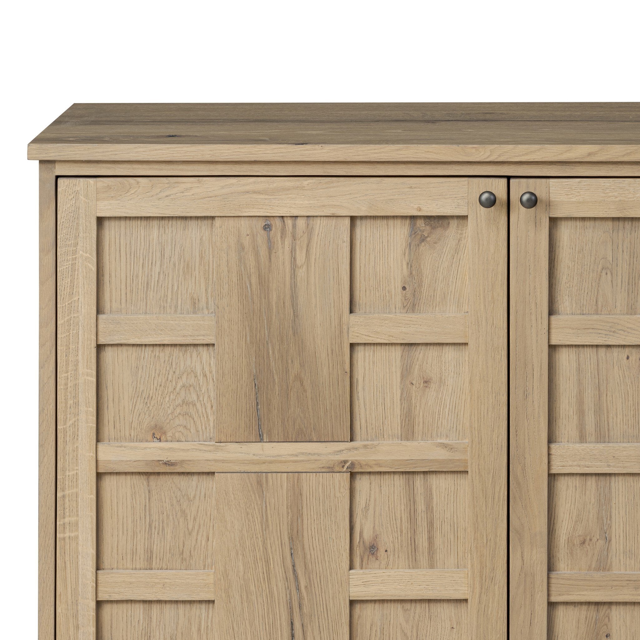 Close up of a wood sideboard with a grid like pattern on the doors on a white background.