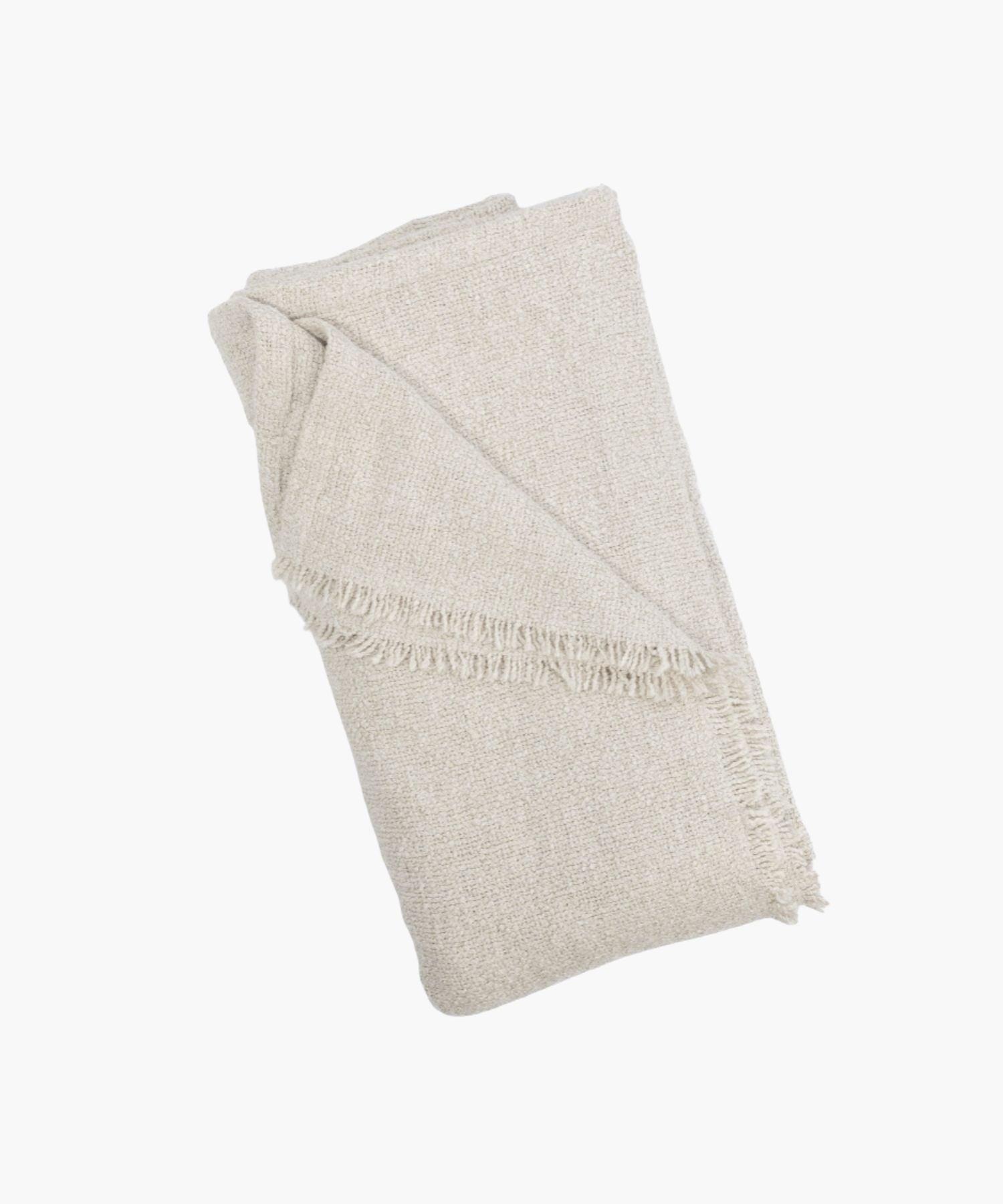Folded cream coverlet with a boucle texture and short fringe detail at the edge. | S.W. Home