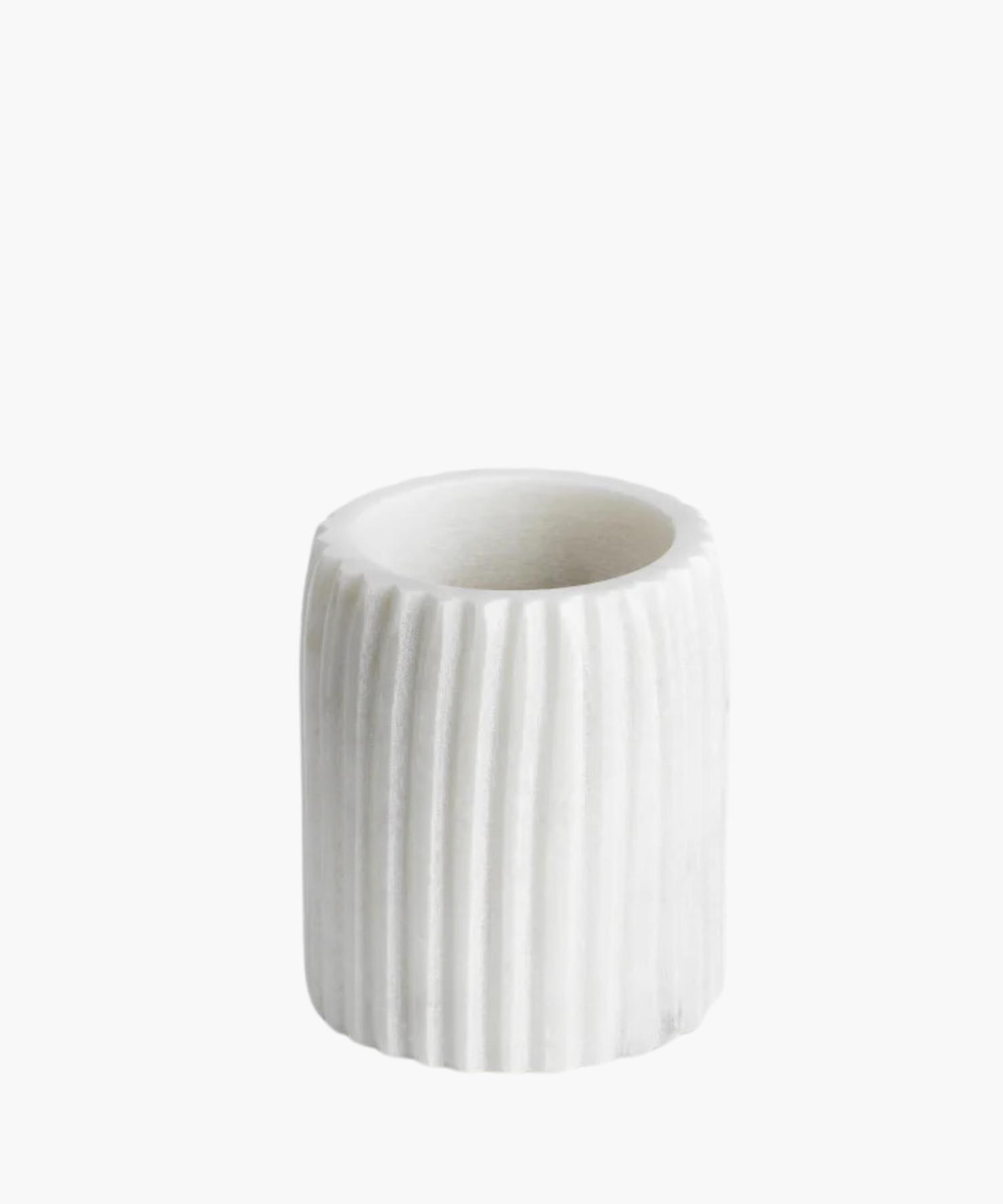 White cylindrical marble tumbler with vertical ridges stands on a white background. The tumbler is simplistic and elegant, exuding a modern, minimalistic vibe. | S.W. Home
