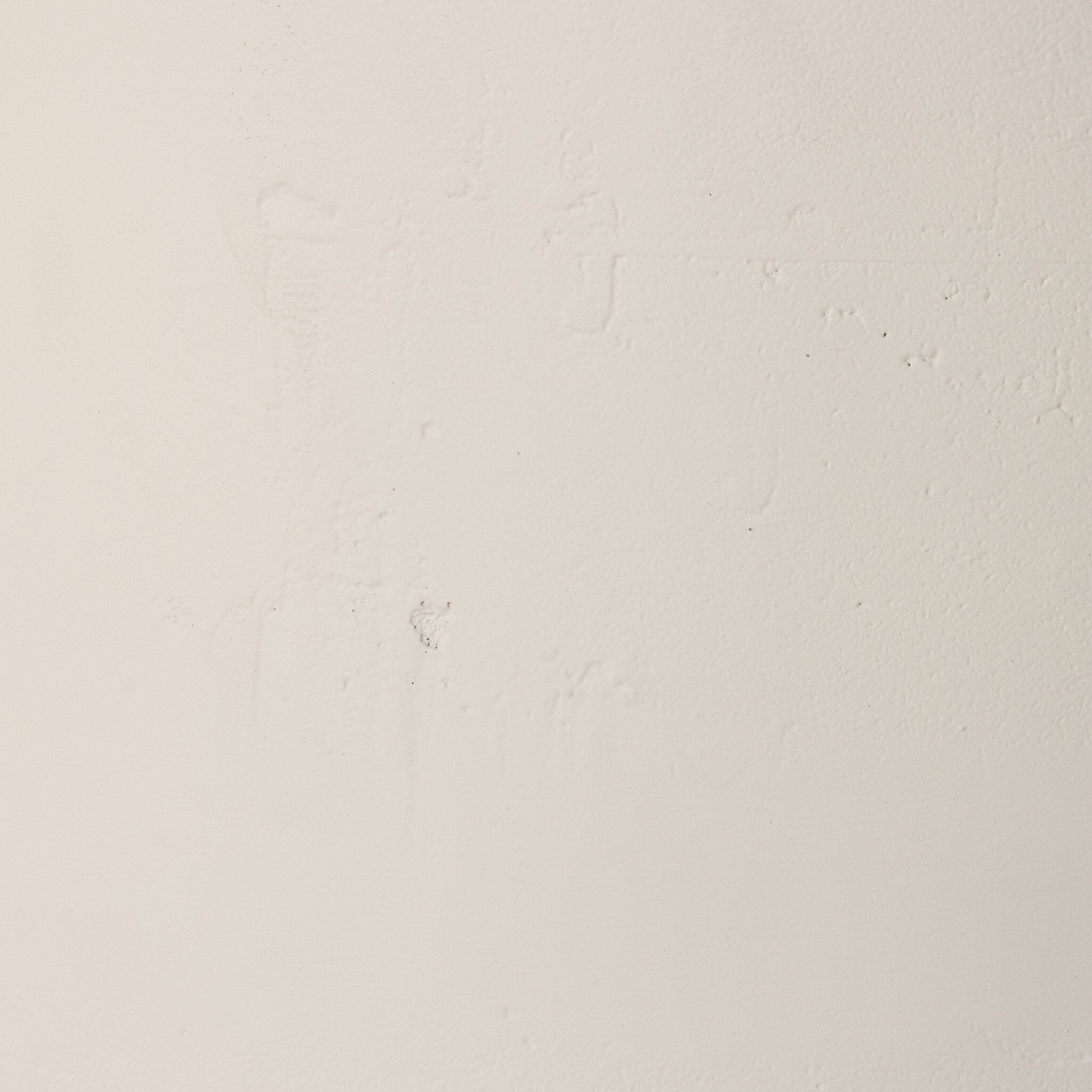 Close up of the white drink table showing its matte finish and subtle texture. 