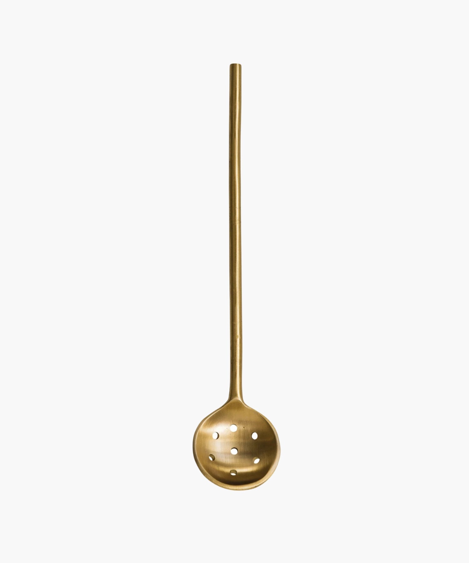 A minimalist brass slotted spoon with a long handle and round, perforated ladle, evoking elegance and simplicity. | S.W. Home