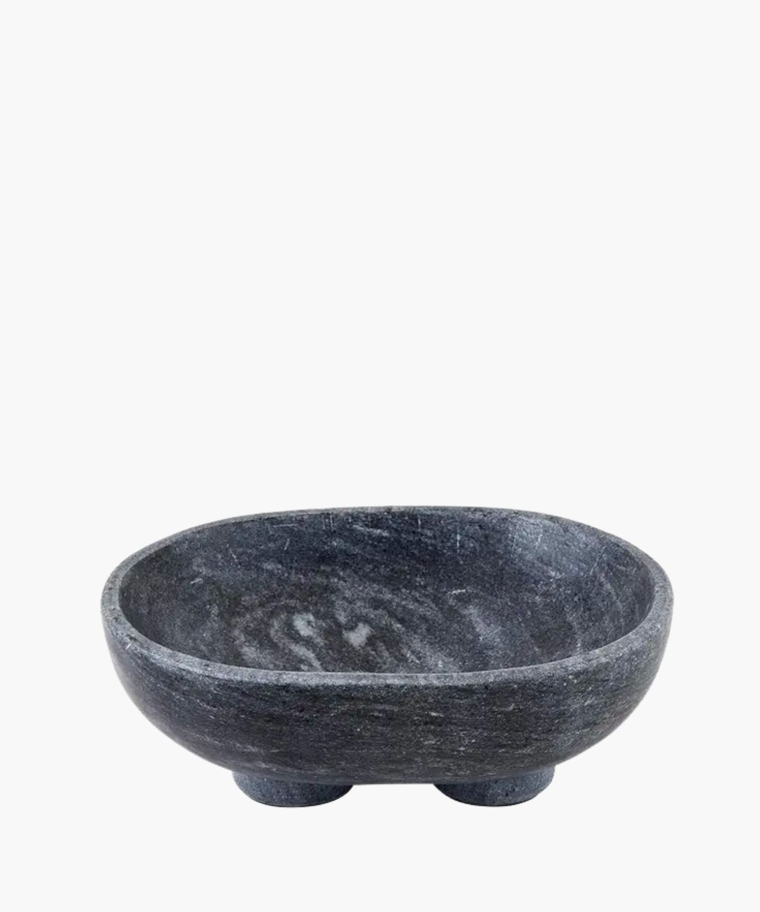 A smooth, dark charcoal gray marble bowl with subtle white veining, sits on two rounded feet. The bowl has a minimalist and modern design. | S.W. Home