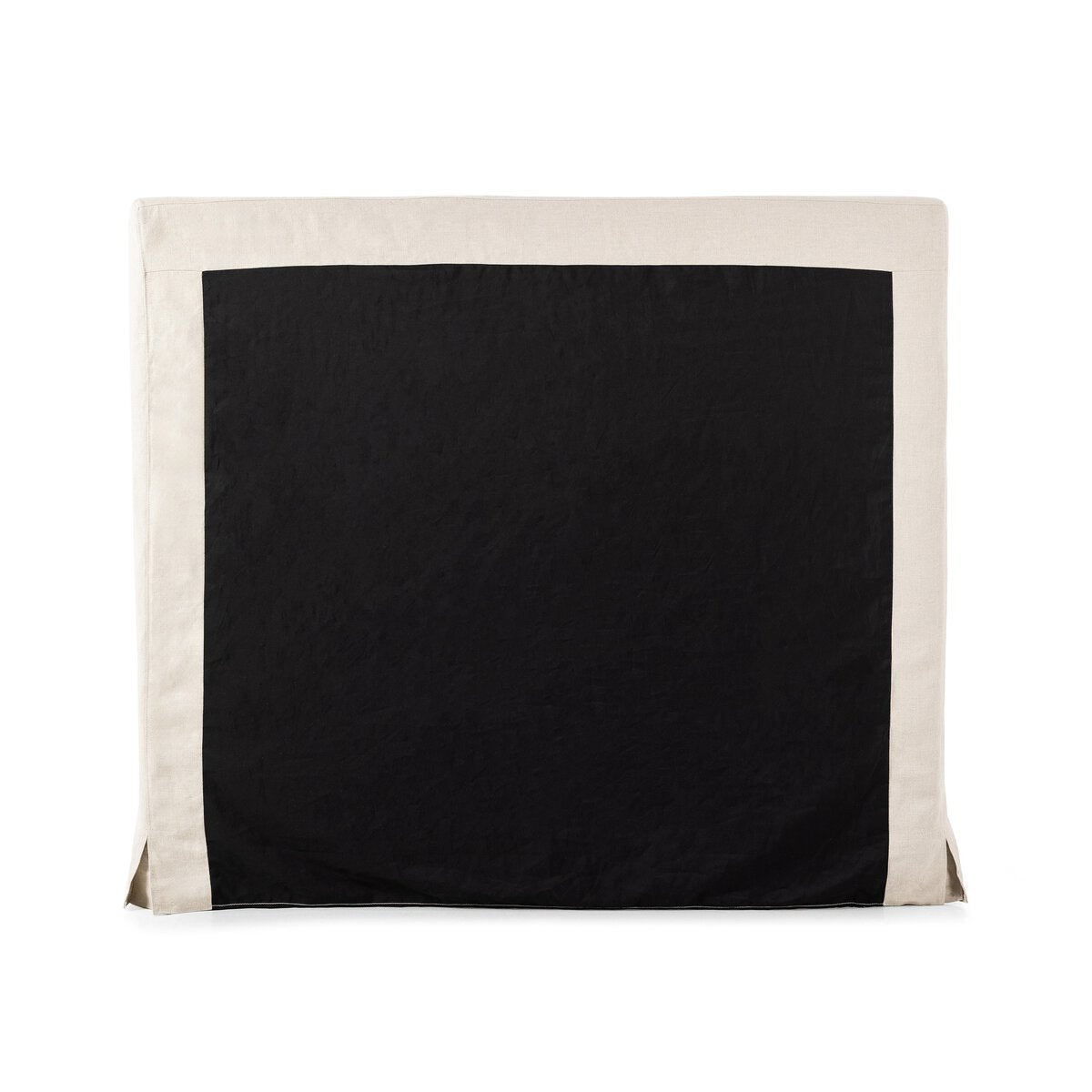 The back of a beige slipcover bed with white bedding on a white background.