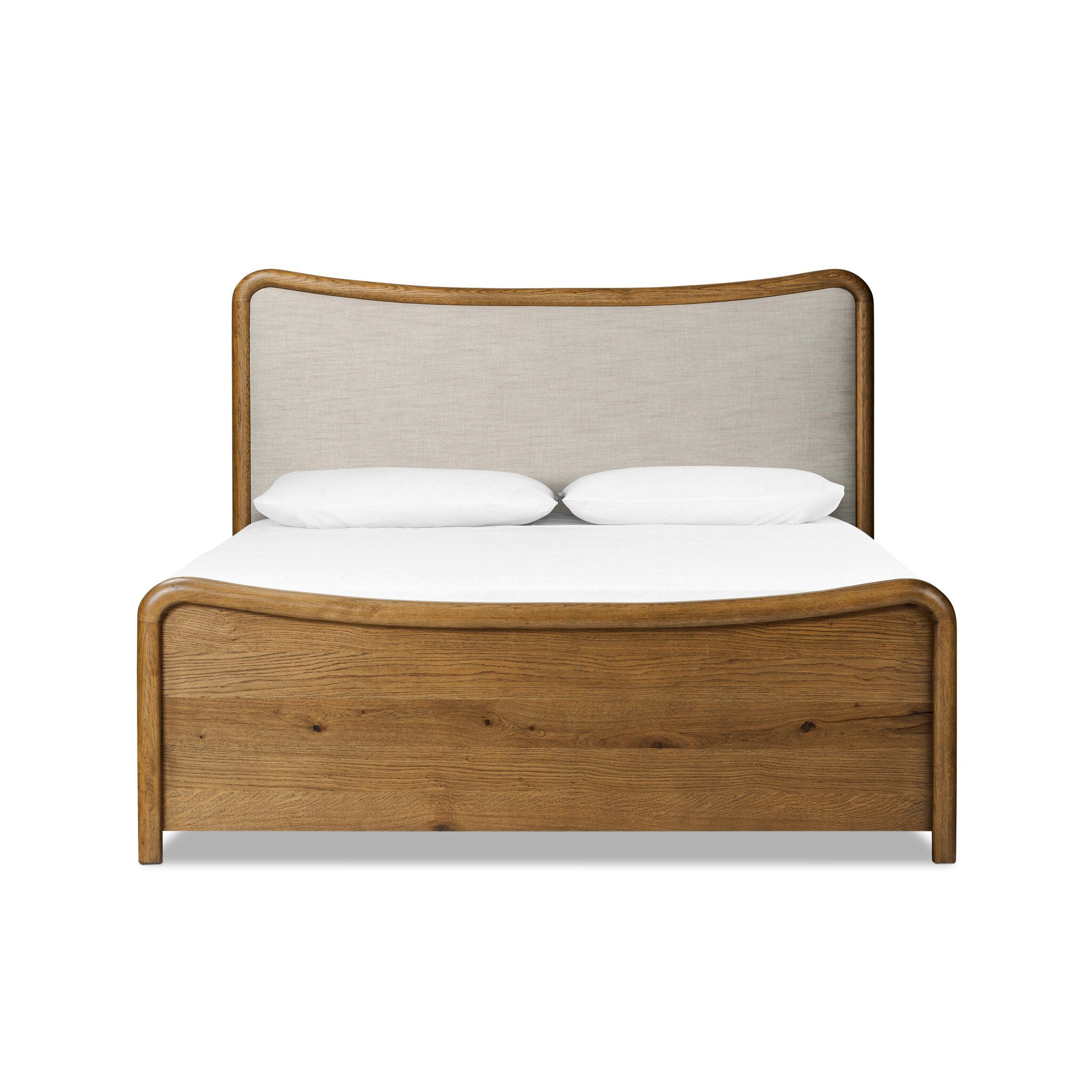 Heritage-inspired oak bed featuring soft curves, linen upholstered headboard, and white bedding on a white background.  | SW Home