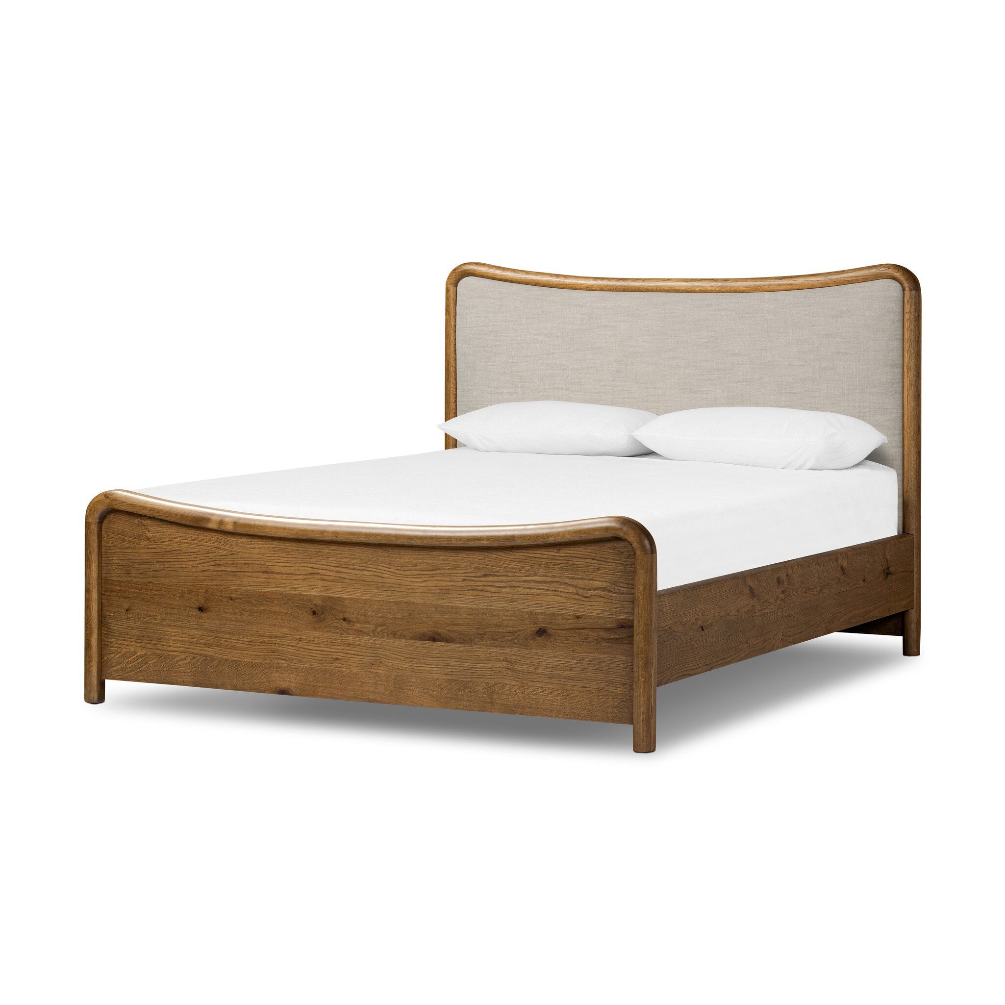 Heritage-inspired oak bed featuring soft curves, linen upholstered headboard, and white bedding on a white background. 