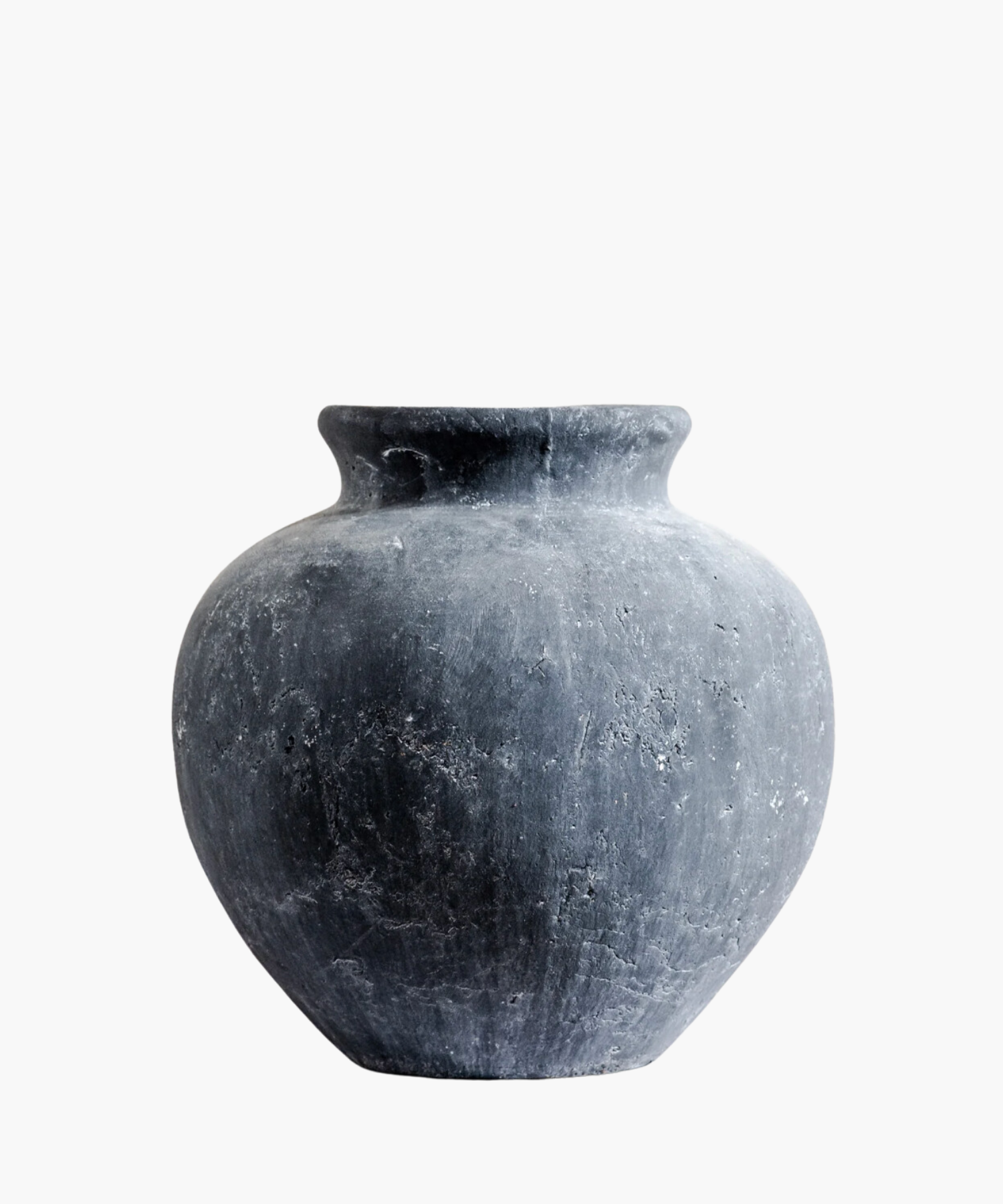 A large, round, weathered gray clay vase with a narrow neck, displaying rough texture and subtle speckles, set against a plain white background. | S.W. Home