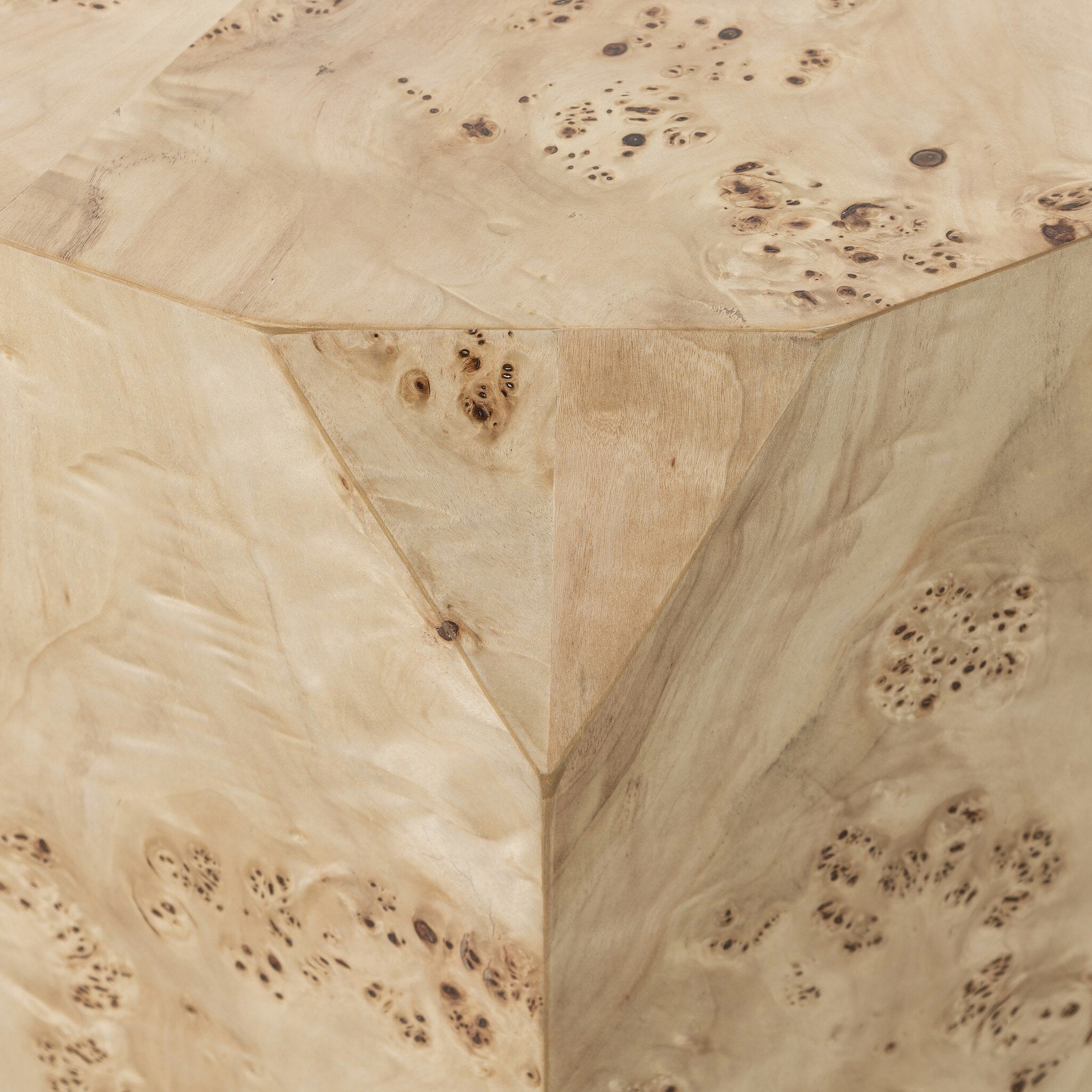 Close up of a wooden end table showing its natural, textured finish on a white background.