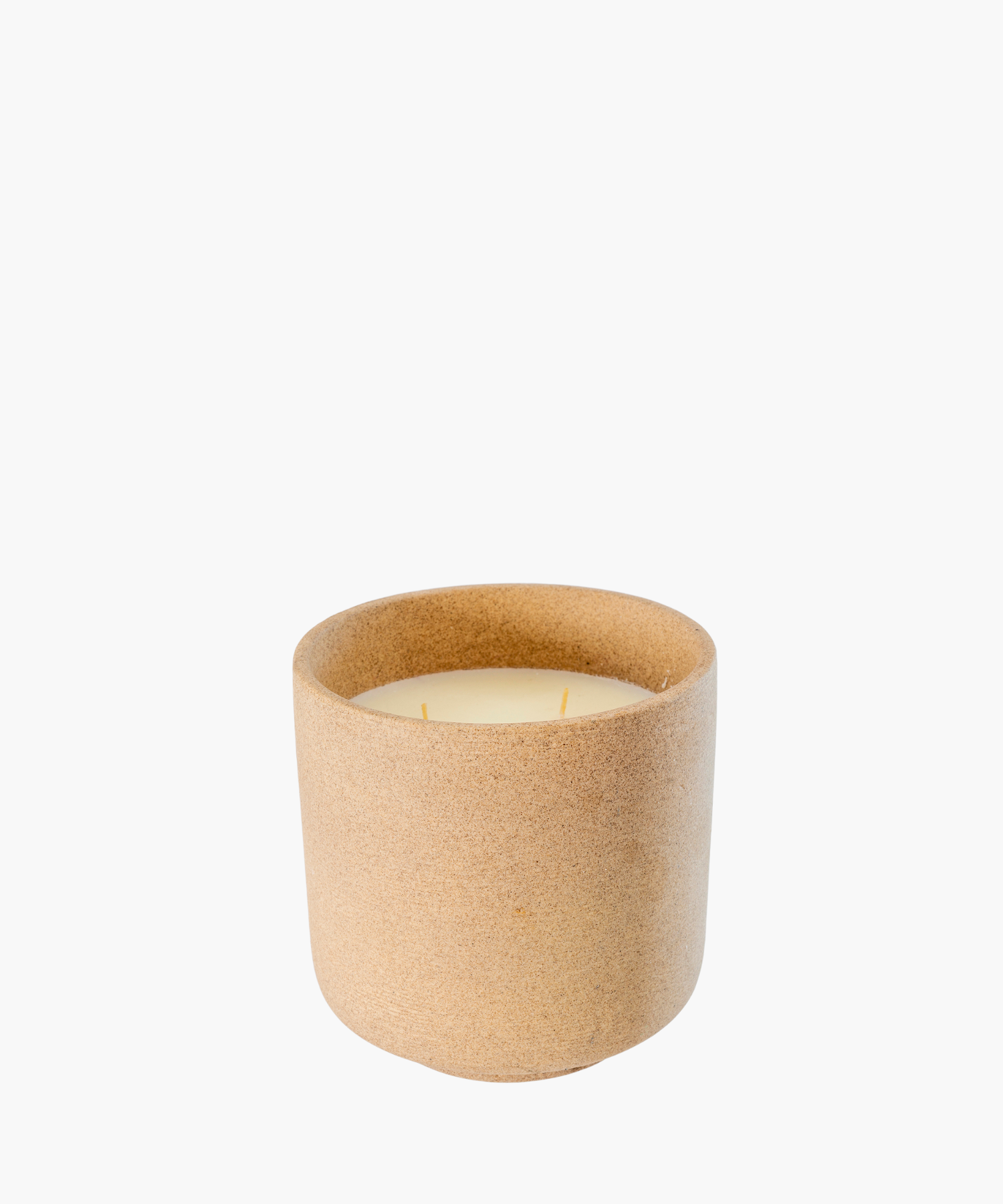 A minimalist light brown ceramic candle holder with smooth texture, containing an unlit cream-colored candle with two wicks, evokes a calm, natural vibe. | SW Home