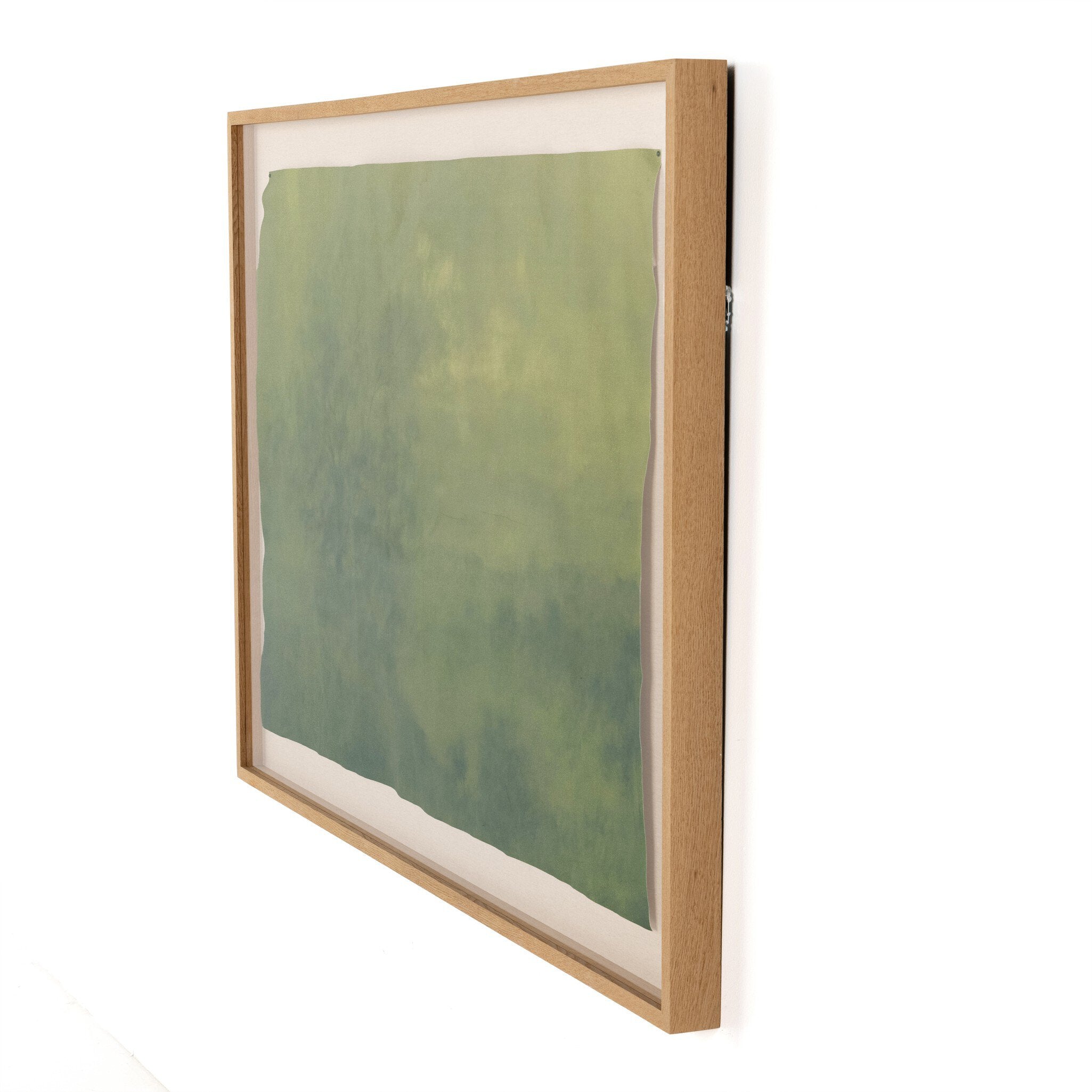 Framed artwork with a green abstract design on a white background. | Wildwood Home Co.
