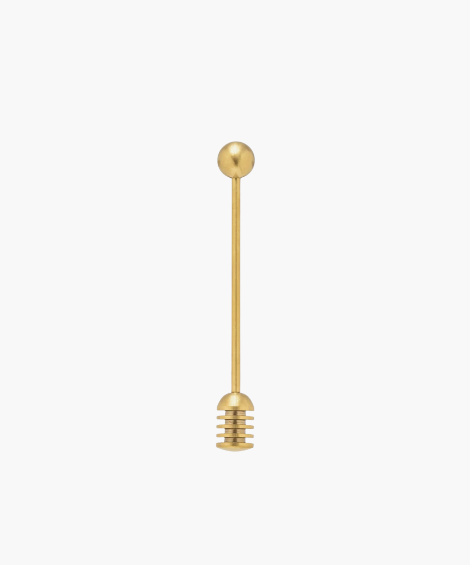 Gold honey dipper with a round handle and grooved end for collecting honey, set against a plain white background. Simple and elegant kitchen tool. | S.W. Home
