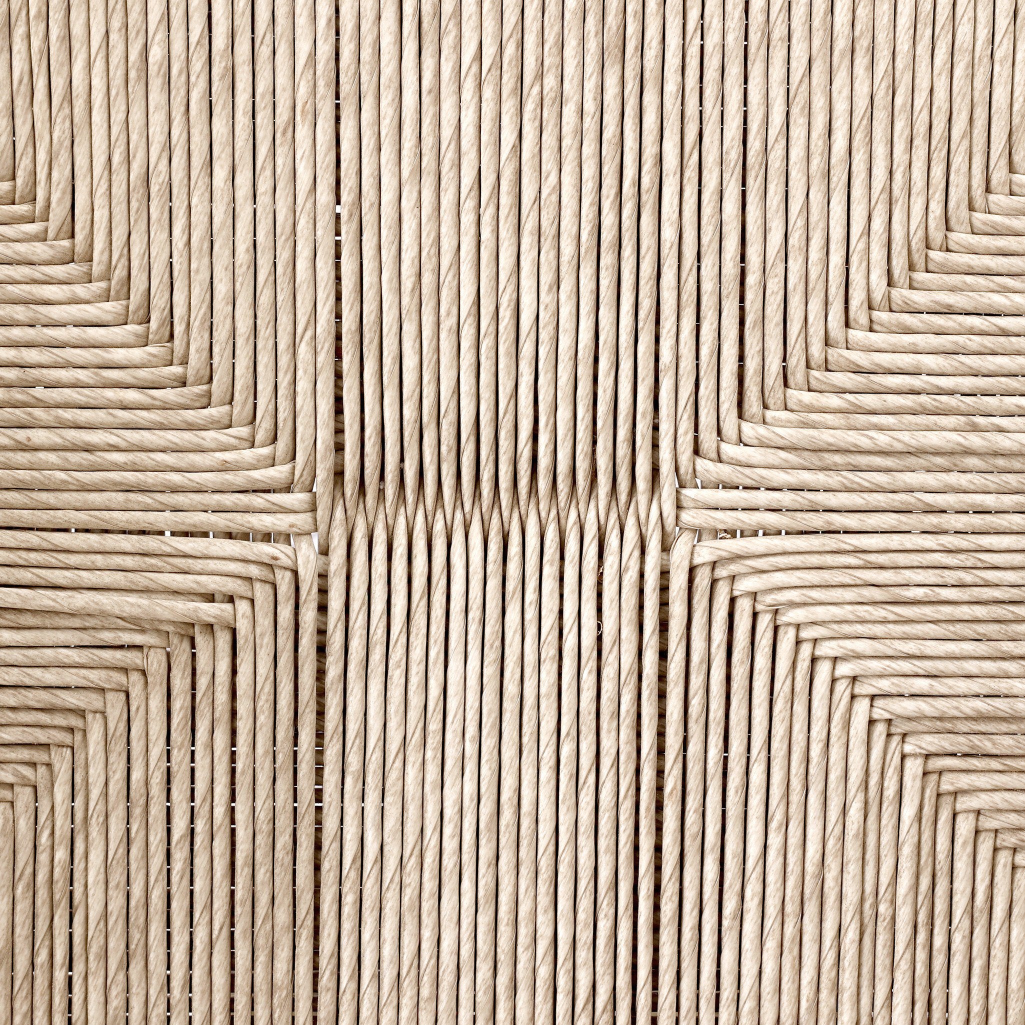 Close up of the woven pattern from the seat of the outdoor dining chair. 
