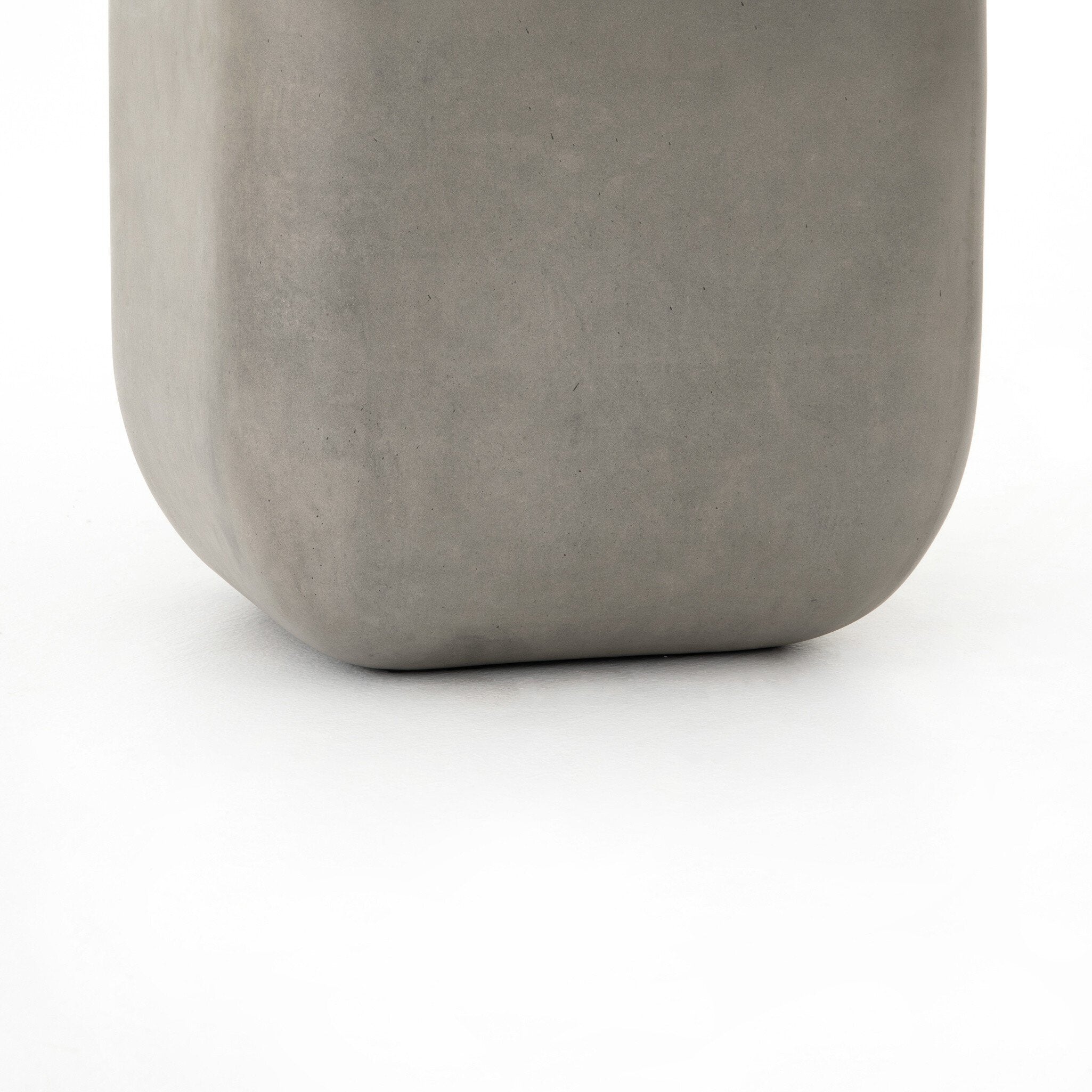 Grey-finished concrete and soft square shaped end table on a white background. 